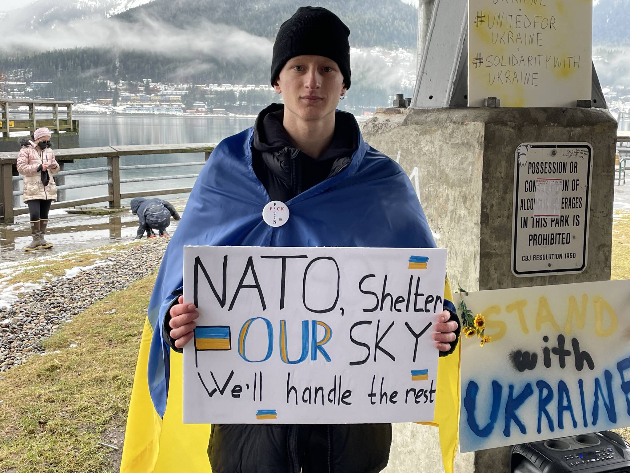 Viktor Tkachenko, who moved to Alaska from Ukraine last year, holds a sign asking NATO for assistance defeating Russian airpower at a protest against the war in Marine Park on Feb. 26, 2022. (Michael S. Lockett / Juneau Empire)