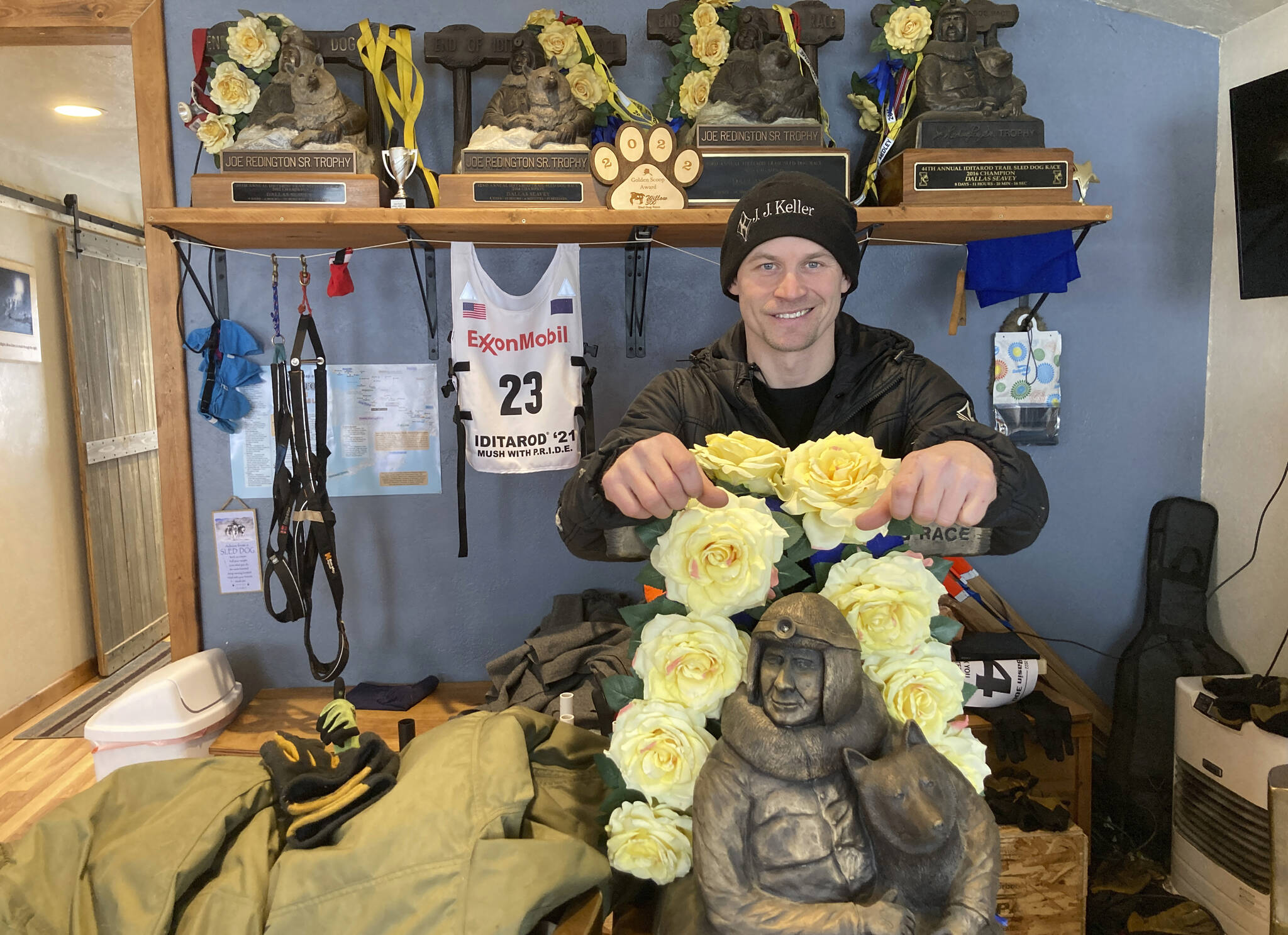 Dallas Seavey is shown Feb. 22, 2022, posing with his five Iditarod Trail Sled Dog championship trophies in Talkeetna, Alaska. Seavey is tied with musher Rick Swenson for the most Iditarod victories ever at five, and Seavey is looking for his sixth title when the Iditarod Trail Sled Dog Race starts this weekend in Alaska. (AP Photo / Mark Thiessen)