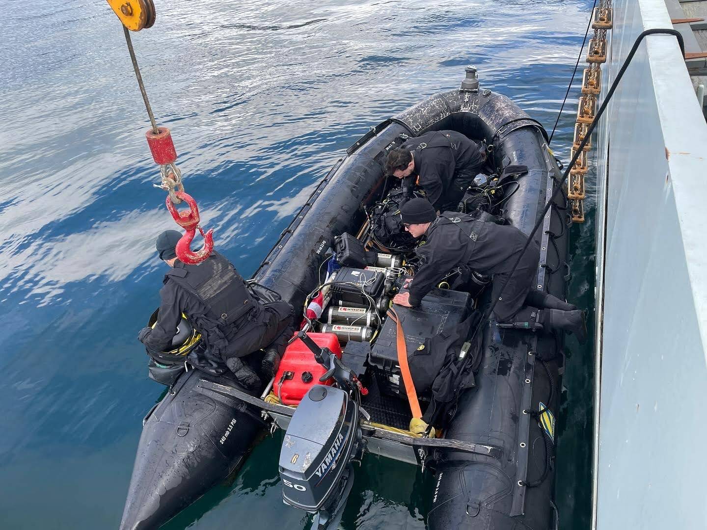 Royal Canadian Navy divers load tanks onto a boat as they prepare to go investigate a simulated naval mine in Stephens Passage on March 6, 2022 as part of exercise Arctic Edge 2022. (Michael S. Lockett / Juneau Empire)