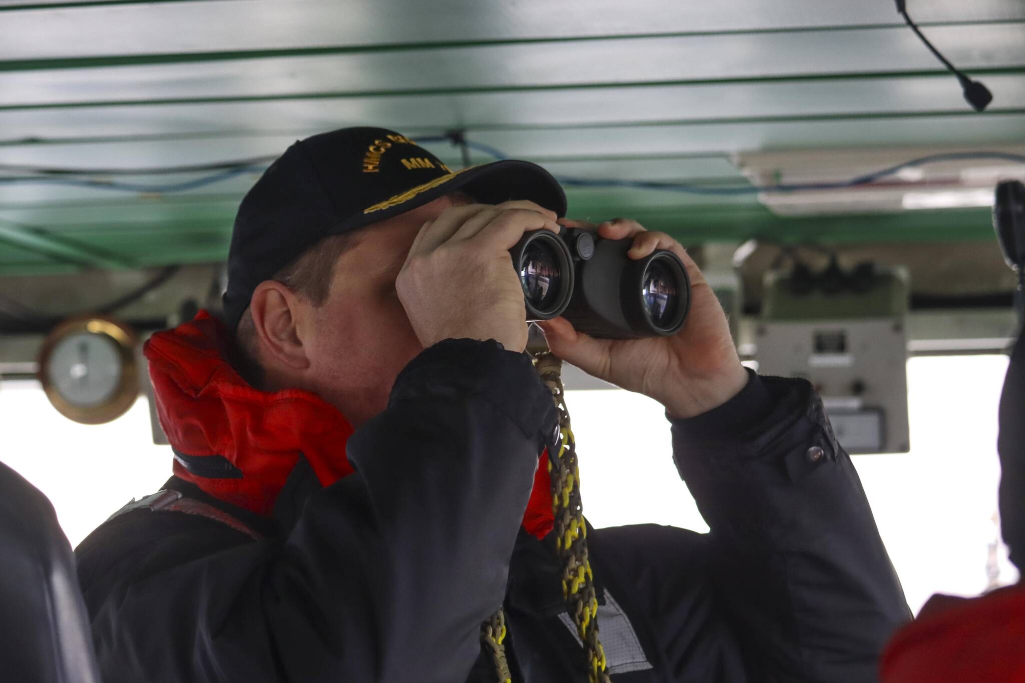 Lt. Cmdr. Mike Wills, captain of Her Majesty’s Canadian Ship Brandon, a minesweeping vessel, looks at a small boat deployed from the ship in the Stephens Passage on March 6, 2022 as part of exercise Arctic Edge 2022. (Michael S. Lockett / Juneau Empire)