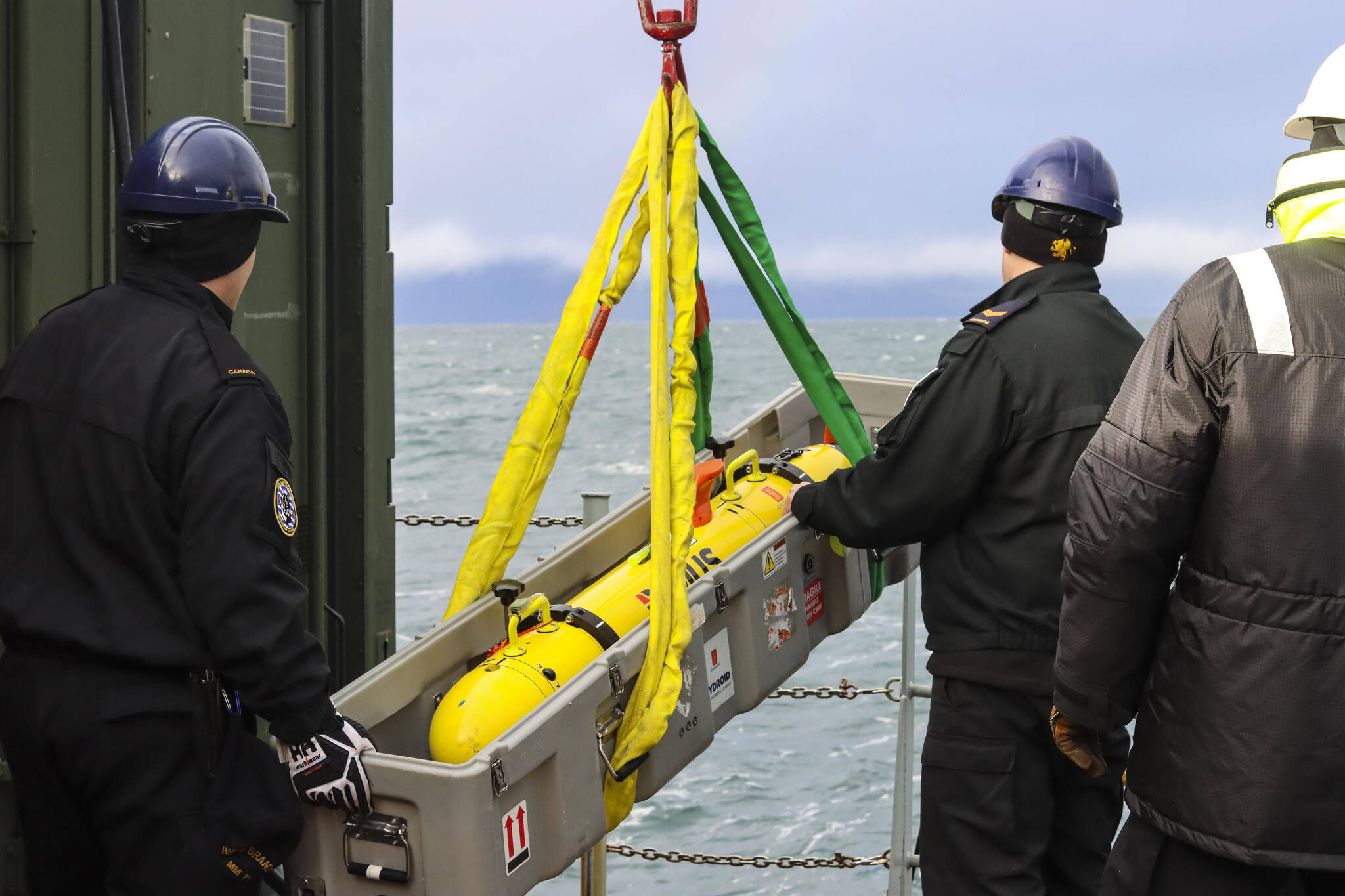 Royal Canadian Navy sailors load the remote environmental monitoring units unmanned underwater vehicle onto a small boat in Stephens Passage on March 6, 2022, as part of exercise Arctic Edge 2022. (Michael S. Lockett / Juneau Empire)