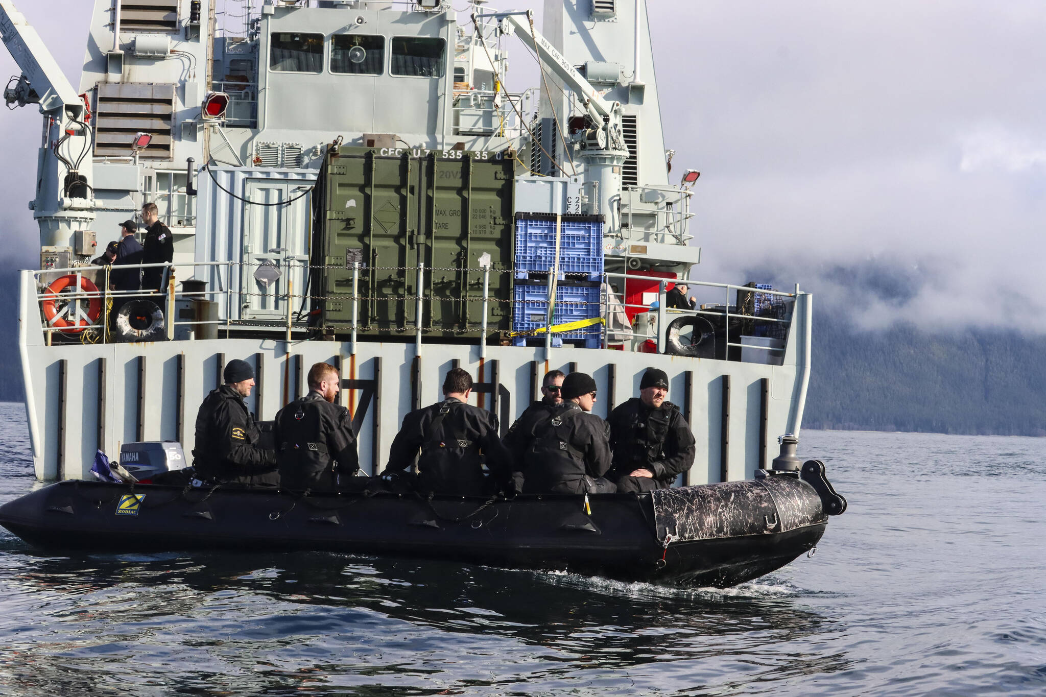Royal Canadian Navy divers navigate aft of Her Majesty’s Canadian Ship Brandon to go investigate a simulated naval mine in Stephens Passage on March 6, 2022, as part of exercise Arctic Edge 2022. (Michael S. Lockett / Juneau Empire)