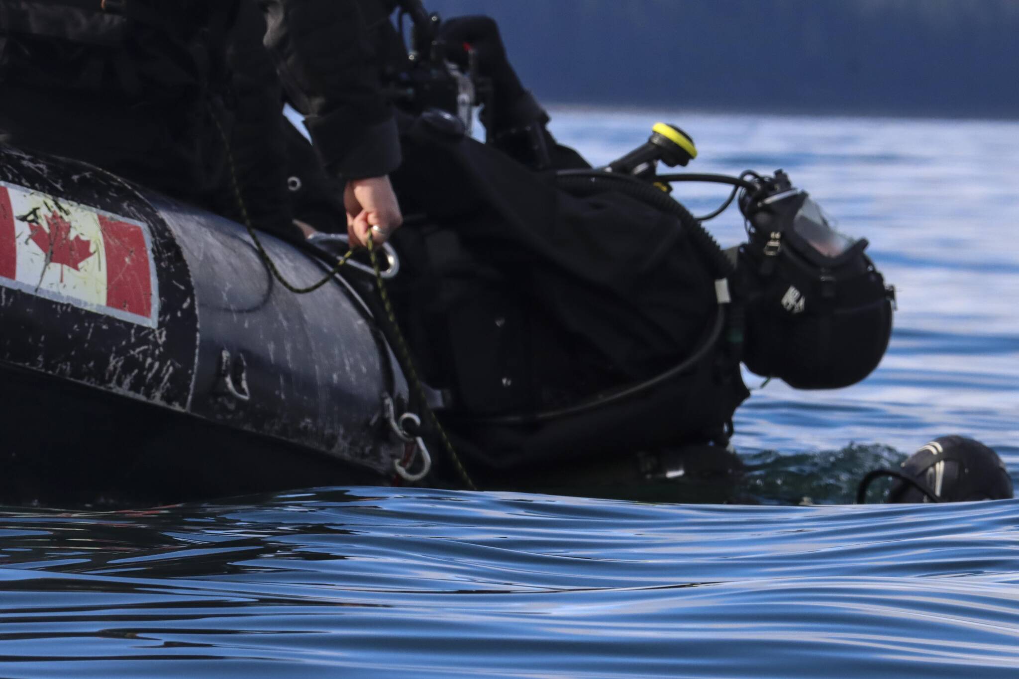 Royal Canadian Navy divers enter the water to go investigate a simulated naval mine in Stephens Passage on March 6, 2022 as part of exercise Arctic Edge 2022. (Michael S. Lockett / Juneau Empire)ckett / Juneau Empire)