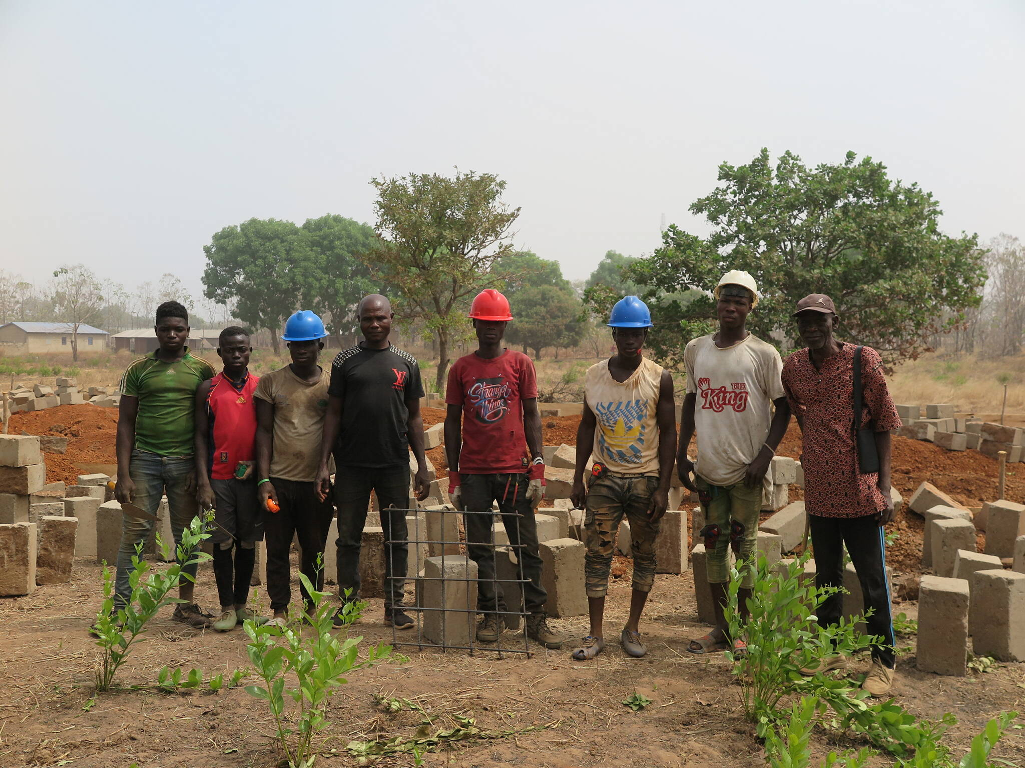 Courtesy photo / Mary McEwen 
Builders and the chief mason, at center in black T-shirt, stand in front of the construction site of a new secondary school in Togo that’s going up with help from a Juneau woman who used to live there.