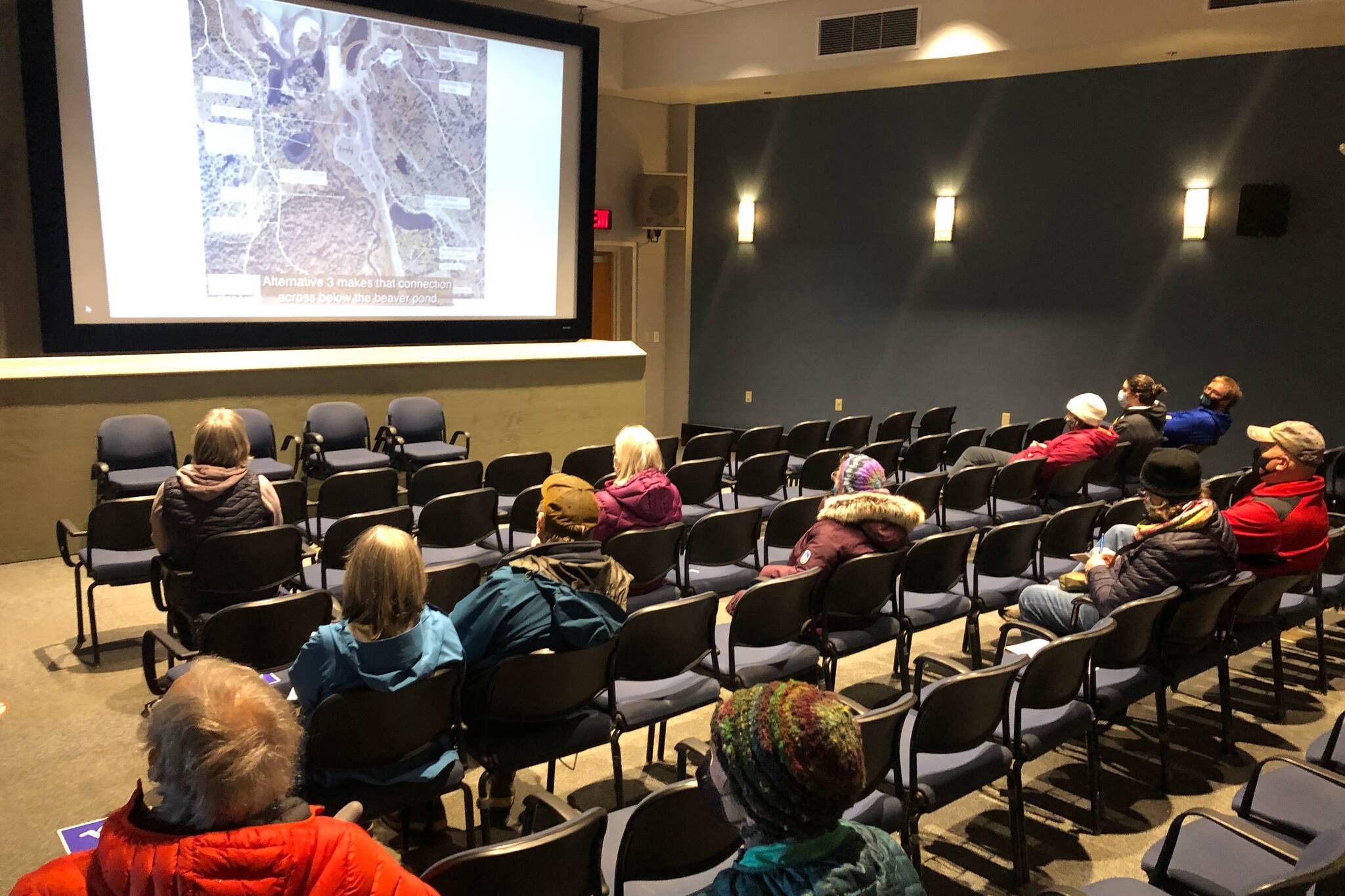 Juneau residents watch a video explaining a planned expansion of the Mendenhall Glacier Visitor Center during an open house at the center on Tuesday, March 15, 2022. (Peter Segall / Juneau Empire)