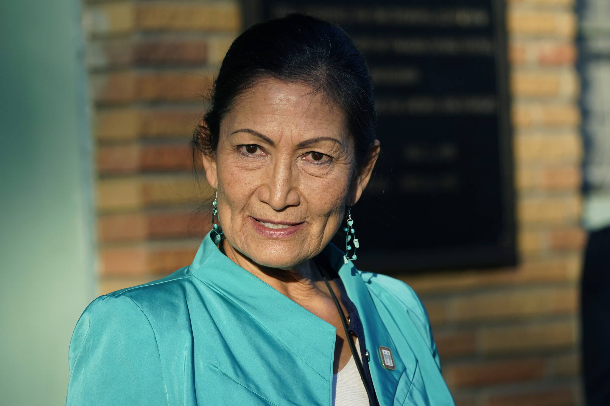 Secretary of the Interior Deb Haaland speaks with reporters while standing outside the Medgar and Myrlie Evers Home National Monument in Jackson, Miss., on Feb. 15, 2022. The Interior Department is on the verge of releasing a report on its investigation into the federal government’s past oversight of Native American boarding schools. Interior Secretary Deb Haaland said Wednesday, March 16, 2022, the report will come out next month. (AP Photo/Rogelio V. Solis, File)