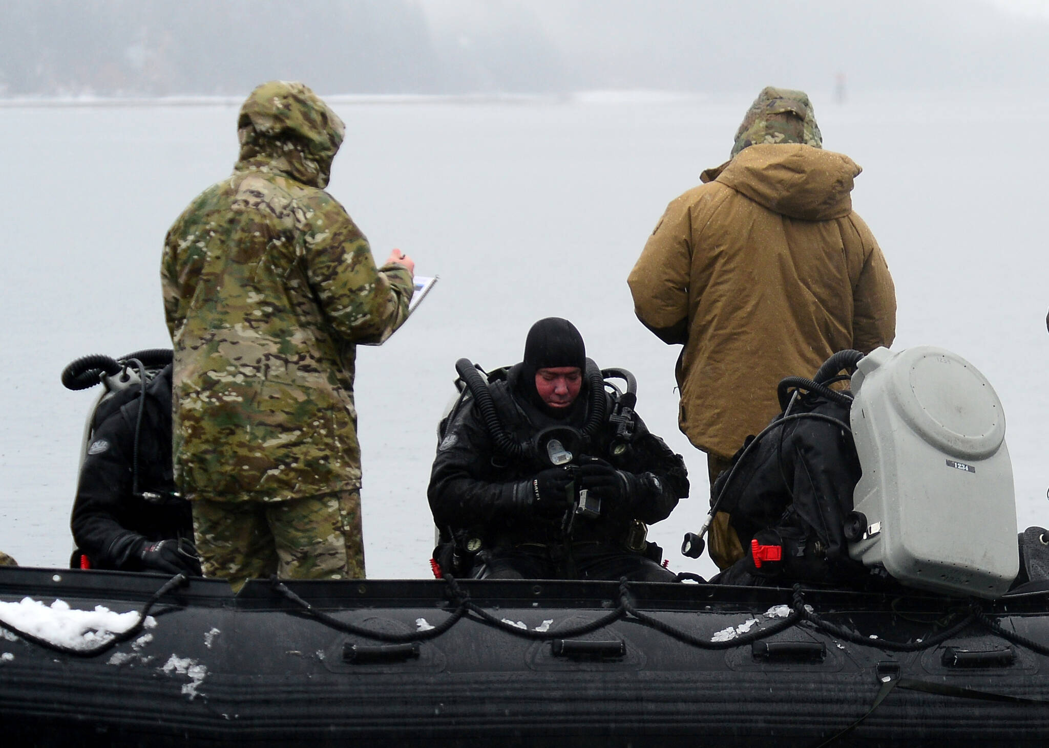Navy explosive ordnance disposal technicians, assigned to Explosive Ordnance Disposal Mobile Unit (EODMU) 1, conduct safety checks prior to dive operations to reacquire, identify and neutralize inert mine shapes in the Gastineau Channel near Juneau, Alaska, March 11, 2022, as part of Exercise Arctic Edge 2022 (U.S. Navy / Lt. John J. Mike)
