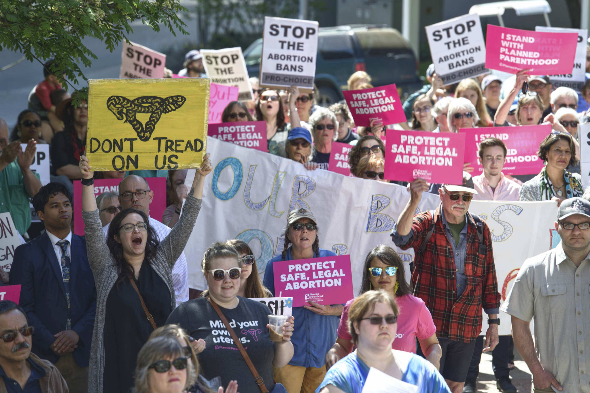 This May 21, 2019, photo shows people attending a rally against anti-abortion laws at the Dimond Courthouse Plaza in Juneau, Alaska. Alaska voters this year will be asked if they want a constitutional convention, and simmering anger over the legislature’s failure to settle the issue of how big a check residents should receive from the state’s oil wealth fund could provide a tail wind for groups seeking to change the constitution on a range of hot button topics, such as abortion. (Michael Penn/ Juneau Empire File)