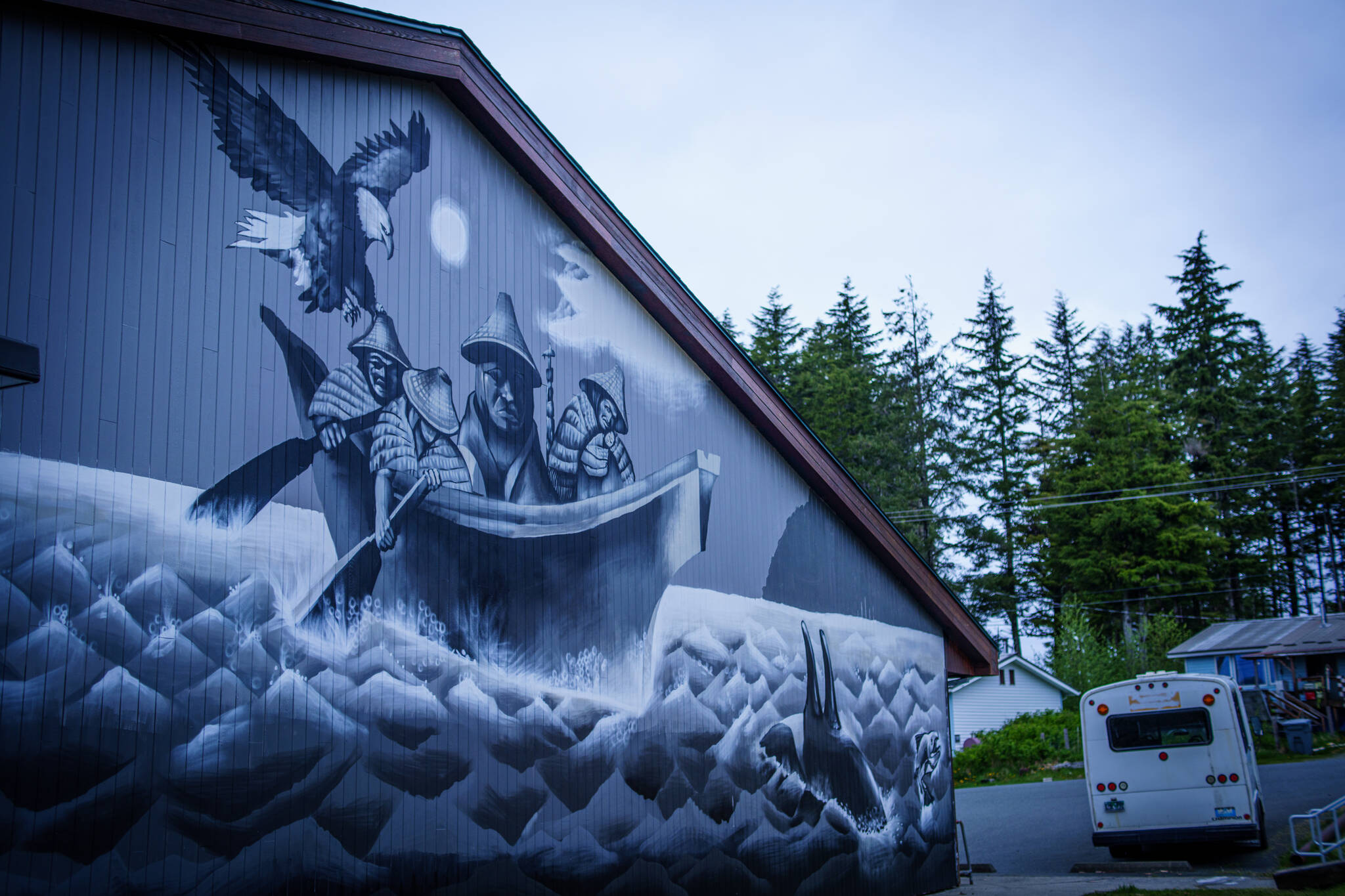 In March 2020, Hydaburg began displacing thousands of gallons of expensive imported heating oil with low-grade waste wood to heat their school buildings. Photo of the school building with the beautiful new mural by Haida artist Andrew Morrison, (Courtesy Photo / Bethany S Goodrich)