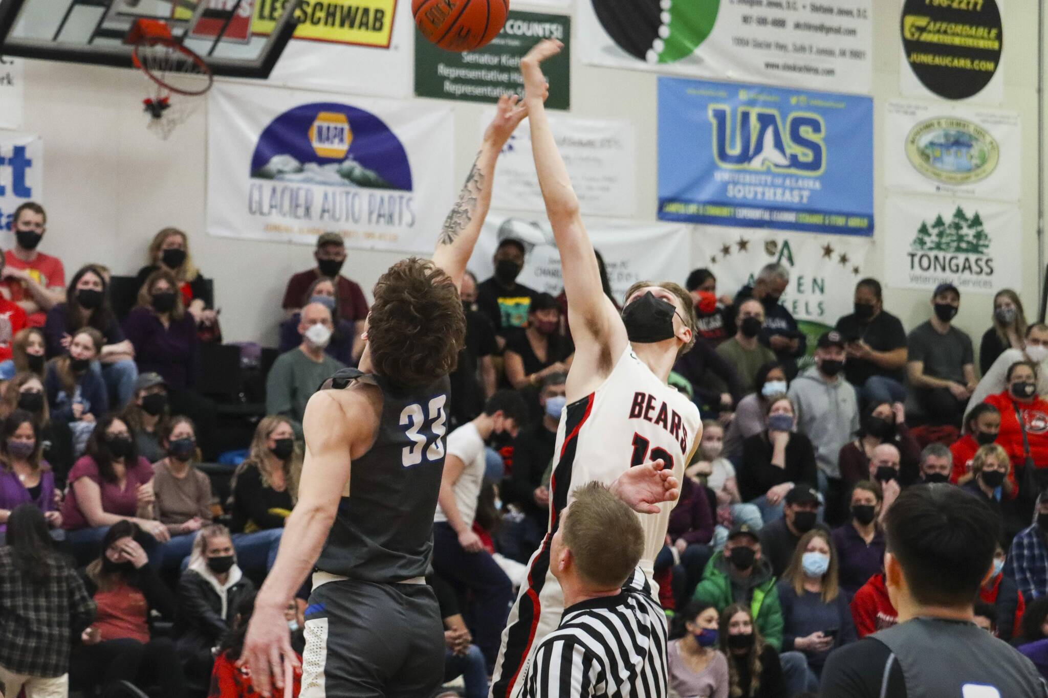 JDHS Jake Sleppy, right, vies for the ball in a tipoff against TMHS during the regular basketball season. JDHS just ended their season with an unsuccessful championship attempt. (Michael S. Lockett / Juneau Empire File)