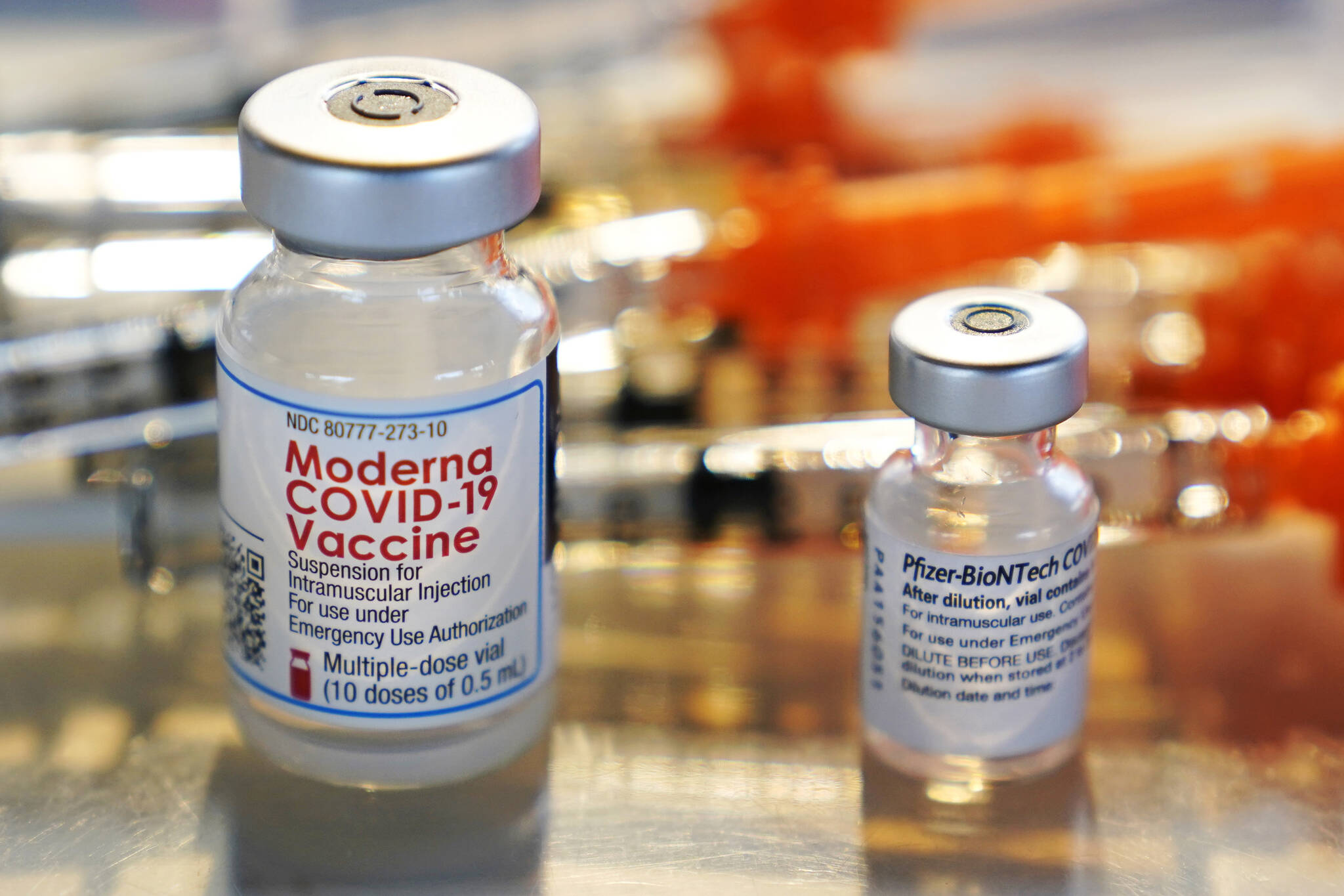 Vials for the Moderna and Pfizer COVID-19 vaccines are seen at a temporary clinic in Exeter, N.H. on Thursday, Feb. 25, 2021. The Food and Drug Administration has authorized another booster dose of the Pfizer or Moderna COVID-19 vaccine for people age 50 and up, Tuesday, March 29, 2022. (AP Photo / Charles Krupa)