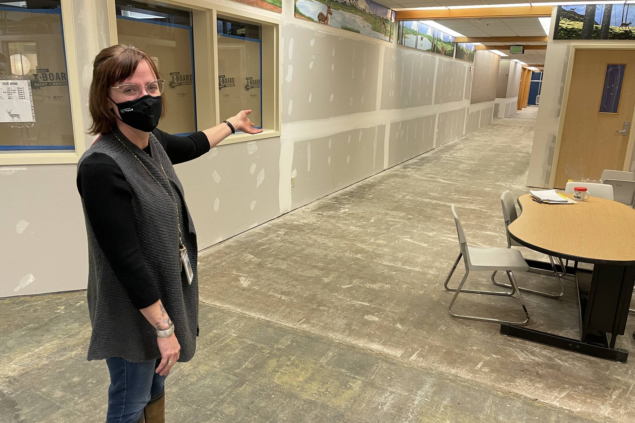 Michael S. Lockett / Juneau Empire 
Riverbend Elementary School principal Elizabeth Pisel-Davis gestures at the walls and concrete floors left bare following massive flooding from a burst pipe in the school in January.