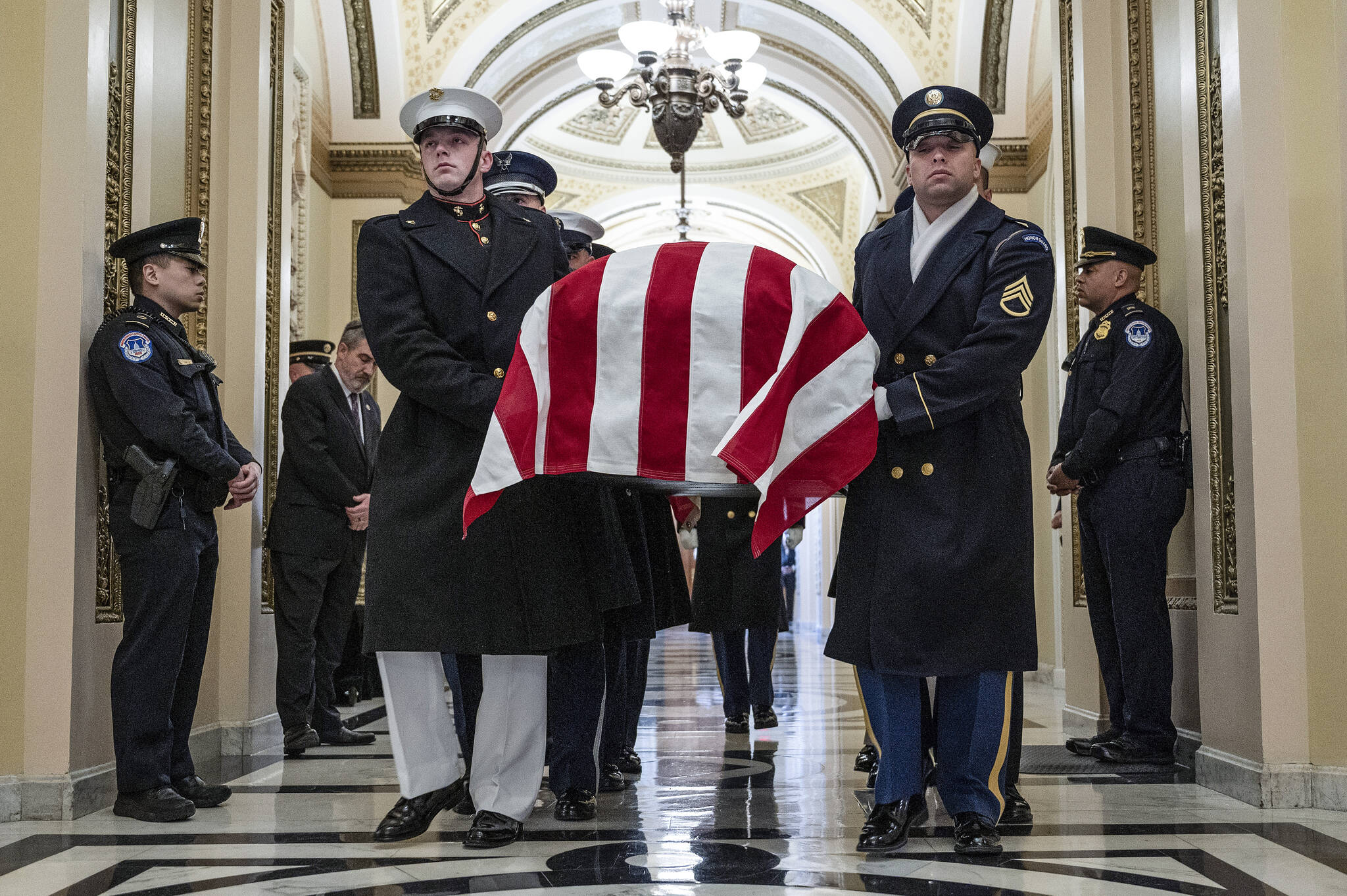 An honor guard carries the flag-draped casket of former Rep. Don Young, R-Alaska, into the U.S. Capitol where he will lie in state in Washington, Tuesday, March 29, 2022. (Jim Watson/Pool Photo via AP)