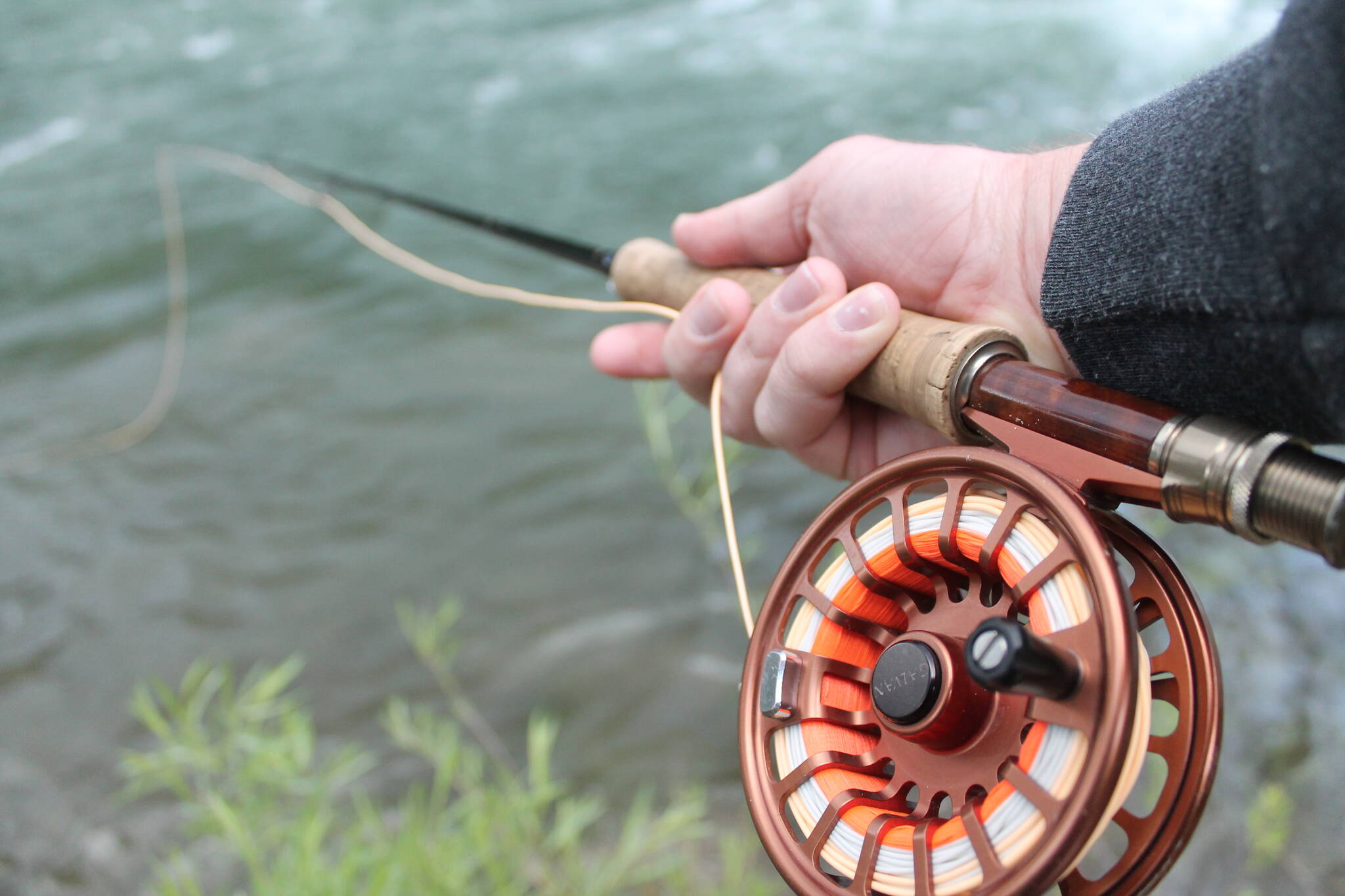 The author thought this reel was about five years old, but this photo from a trip to the Truckee River in California seven years ago made him realize just how long his favorite reel has been around. (Jeff Lund / For the Juneau Empire)