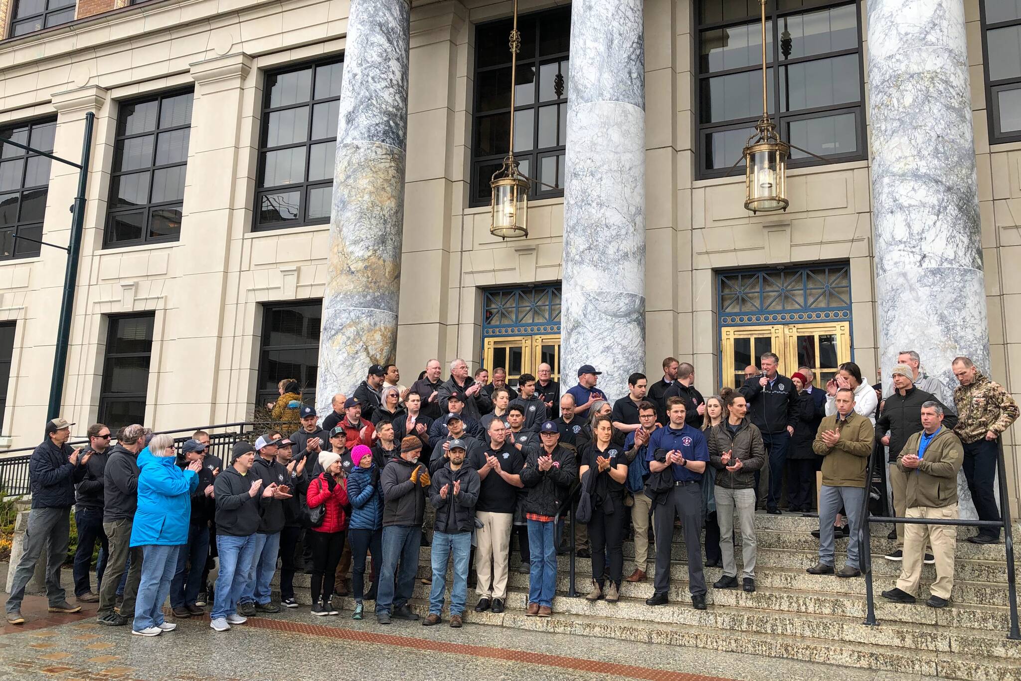 State and municipal public safety employees gathered on the steps of the Alaska State Capitol on Thursday, March 31, 2022, to urge senators to act on a bill to rework the state’s pension system for police, firefighters and other public safety employees. (Peter Segall / Juneau Empire)