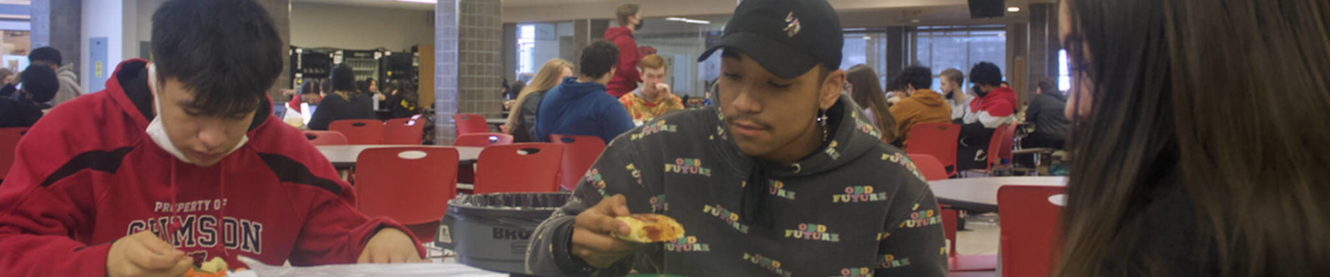 A.J. Wilson, 17, DeAndre Pittman, 16, and Elora Johnson, 16, eat lunch Thursday in the Juneau-Douglas High School: Yadaa.at Kalé cafeteria. They, like many students, agree the free meals available during the pandemic are worth continuing if funding can be found after it ends June 30, but they are likely to look off-campus for food if they are required to pay for school lunches again. (Mark Sabbatini / Juneau Empire)