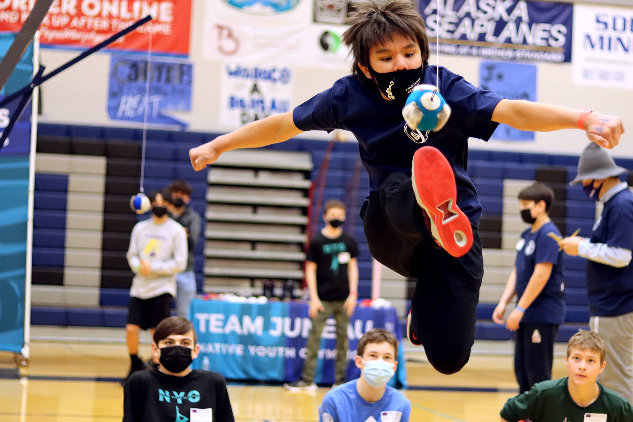Donovan Jackson, 12, of Juneau competes in the one-foot high kick Saturday morning during the 2022 Traditional Games. The games were held at Thunder Mountain High School. (Ben Hohenstatt / Juneau Empire)