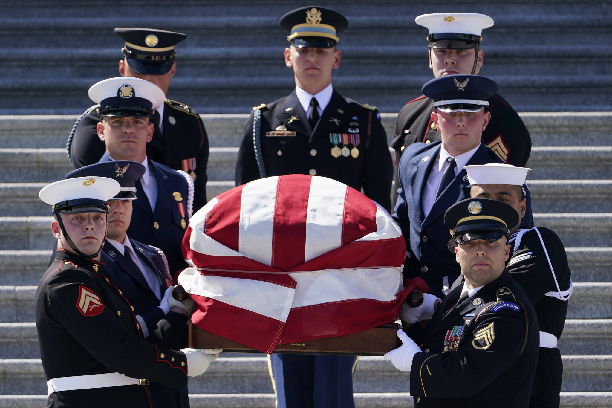 A joint forces honor guard carries the casket of Rep. Don Young, R-Alaska, down the steps of the House of Representatives on Capitol Hill in Washington, Tuesday, March 29, 2022. Young, the longest-serving member of Alaska's congressional delegation, died Friday, March 18, 2022. He was 88. (AP Photo / Susan Walsh)