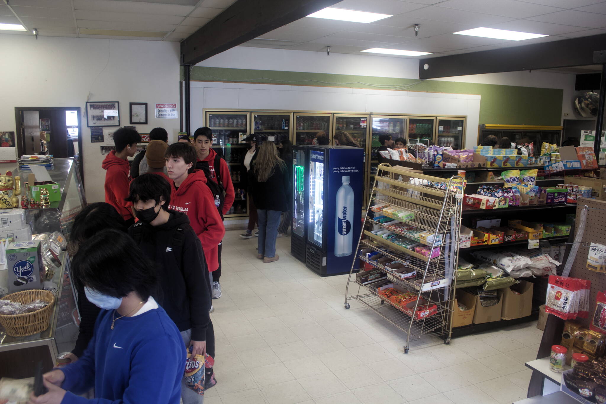 Mark Sabbatini / Juneau Empire 
A line of customers snakes its way around J&J Deli and Asian Mart. While the business is a favorite of government workers and students alike, it is set to close in August unless a buyer is found.
