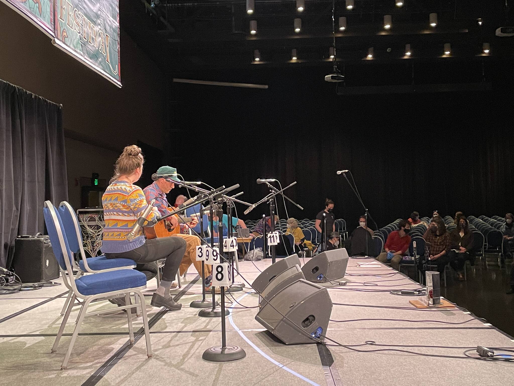 Juneau band The Breeze, made up of Charles Kiel Renick, Olivia Sinaiko and Bob Sinaiko, prepare to play their set at Centennial Hall during the 2022 Alaska Folk Fest on April 4, 2022. (Michael S. Lockett / Juneau Empire)