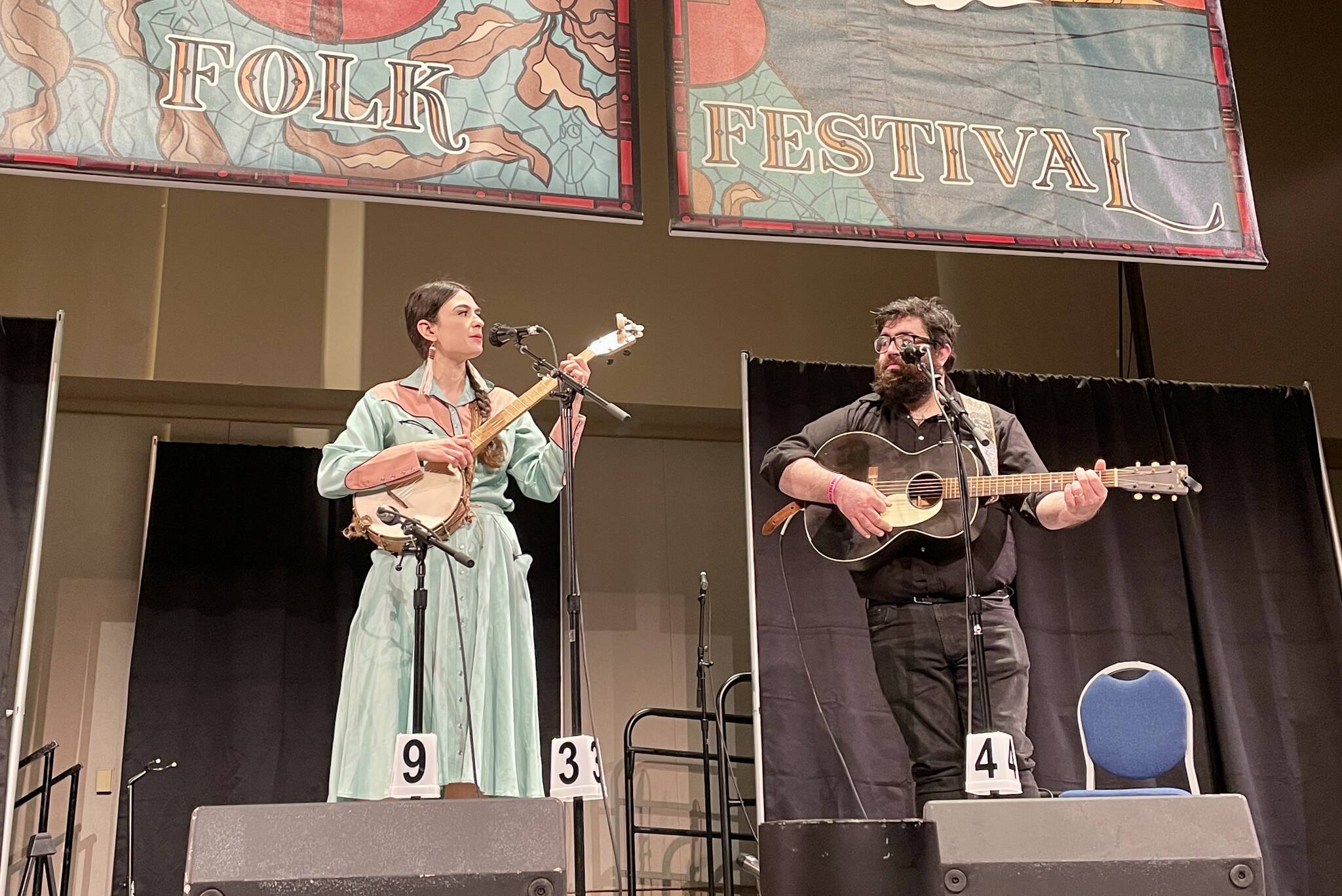 Annie Bartholomew and Miguel Rohrbacher, Juneau artists, kick off the 2022 Alaska Folk Festival to a standing ovation at Centennial Hall on April 4, 2022. (Michael S. Lockett / Juneau Empire)