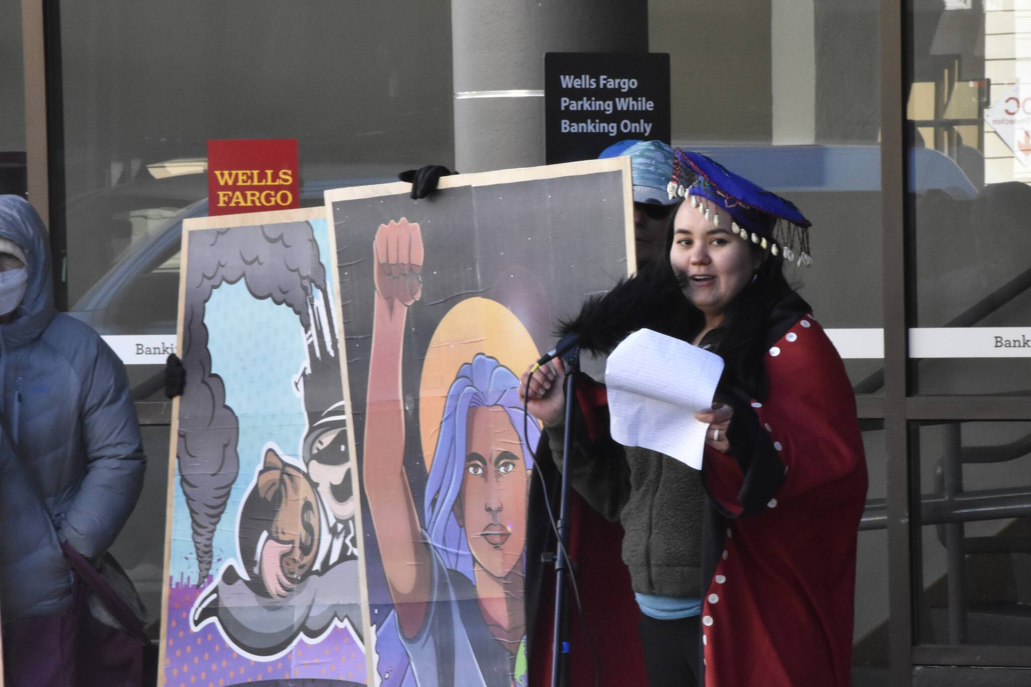 Rebekah Contreras, a local activist with the Women’s Earth and Climate Action Network spoke at a demonstration in front of the downtown Juneau branch of Wells Fargo on Monday, April 11, 2022, urging the company’s leadership to stop funding new fossil fuel projects. (Peter Segall / Juneau Empire)