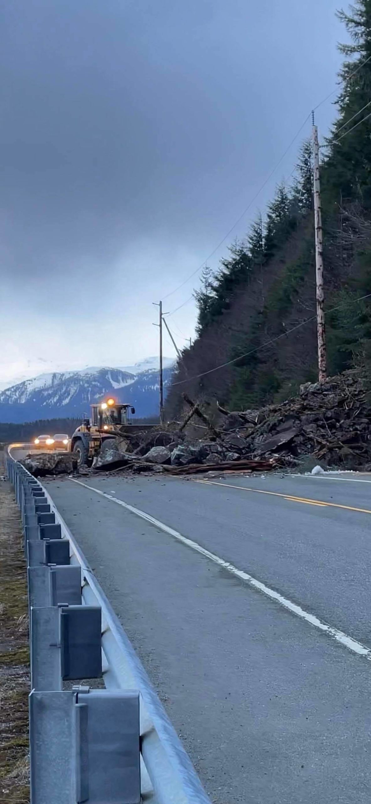Department of Transportation and Public Facilities personnel clear rockslide debris from Douglas Highway on April 6, 2022. (Courtesy photo / Alana Davis)