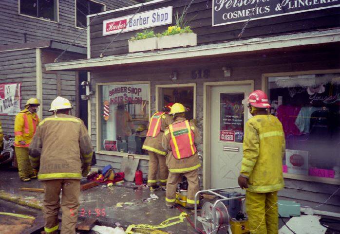 Members of Ketchikan Fire and Rescue work on freeing Janalee Minnich Gage from the boulder, Ketchikan Alaska, May 1995. (Courtesy Photo / Janalee Minnich Gage and Ketchikan Museums)