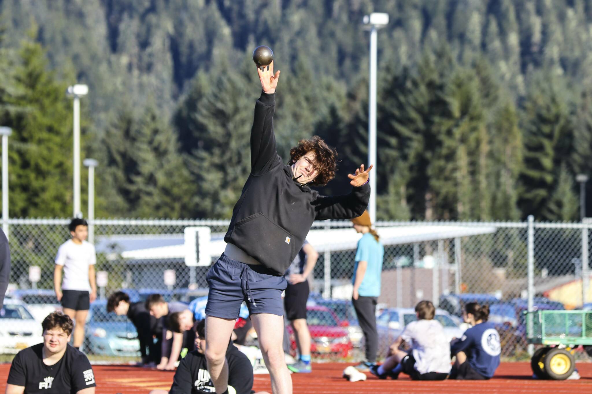 JDHS athlete Robbie Gabel throws the shot put during a practice at TMHS on April 14, 2022. (Michael S. Lockett / Juneau Empire)
