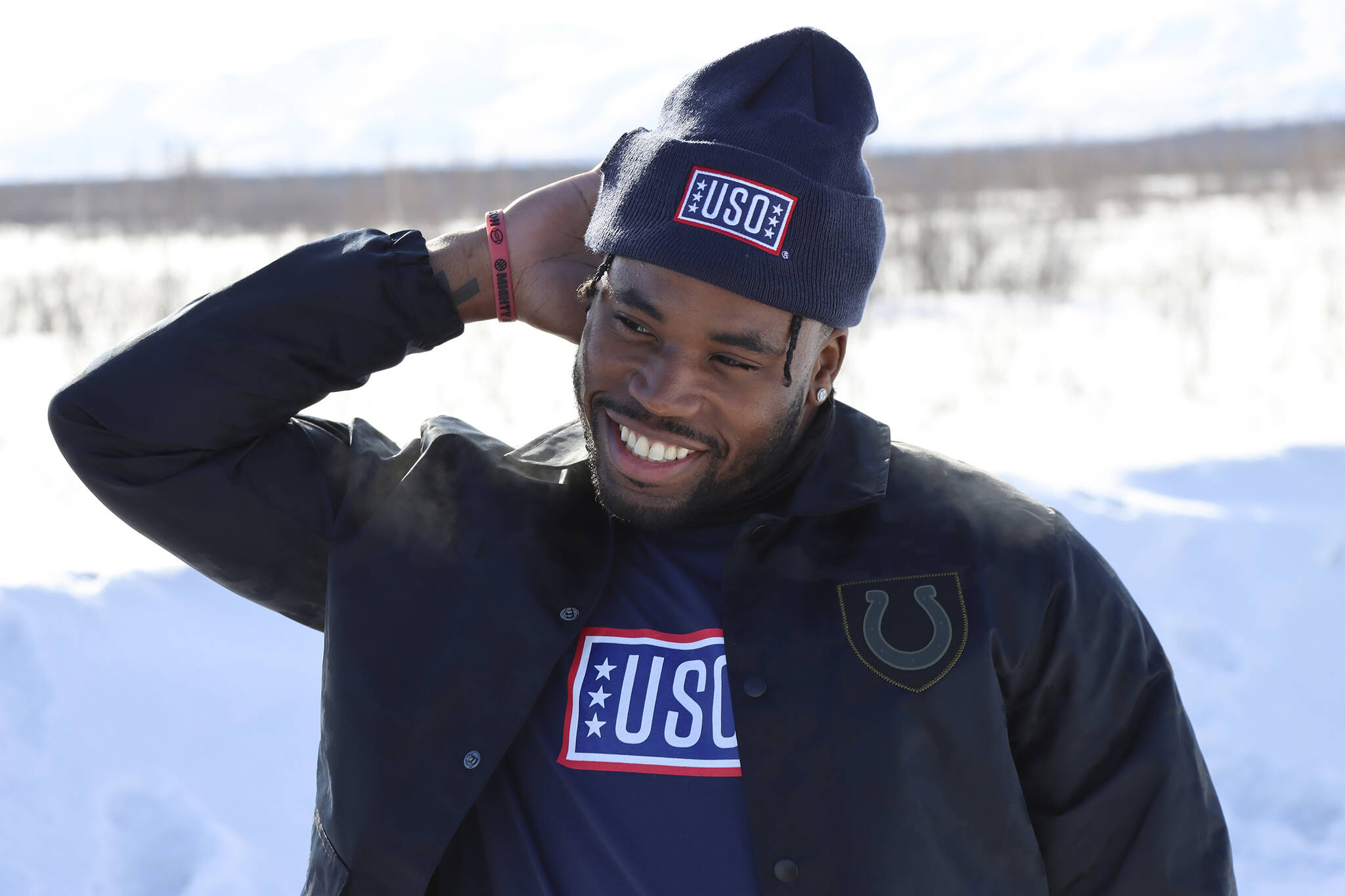 In a photo provided by the NFL, Indianapolis Colts’ Kenny Moore smiles near Fairbanks, Alaska, April 5, 2022, during the 2022 NFL-USO Tour. Moore was awestruck by the conditions military members must battle. And by their resolve and resourcefulness — things any pro athlete can identify with. (NFL)