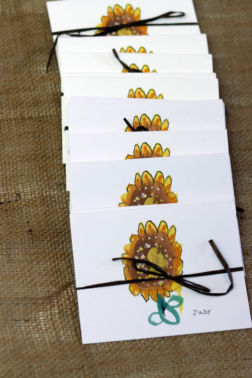 Cards bearing students’ drawings of a sunflower awaited customers on Friday afternoon. (Ben Hohenstatt / Juneau Empire)
