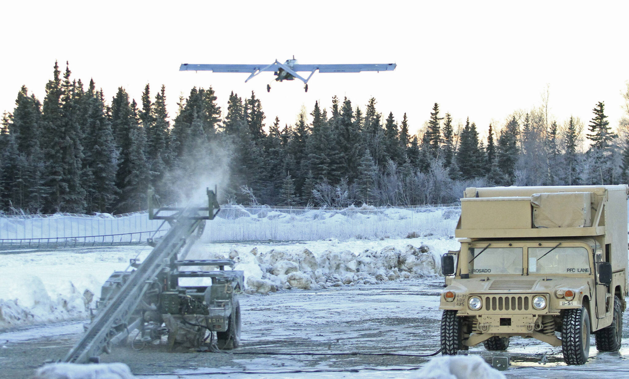 In this Jan. 30, 2014 photo, an RQ7 Shadow unmanned aircraft flies from its pneumatic catapult launcher at Joint Base Elmendorf-Richardson in Anchorage, Alaska. U.S. military bases in the Arctic and sub-Arctic are failing to harden their installations against long-term climate change as required, even though soaring temperatures and melting ice already are cracking base runways and roads and worsening flood risks up north, the Pentagon’s watchdog office said April 14, 2022. (AP Photo / Dan Joling)