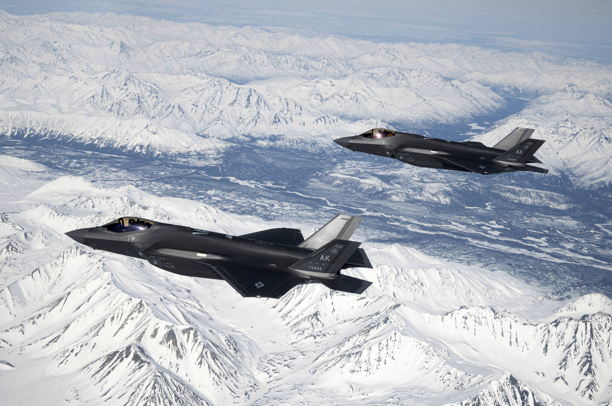 In this photo made available by the U.S. Air Force, two Air Force F-35A Lighting IIs assigned to the 354th Fighter Wing fly over the Joint Pacific Alaska Range Complex, April 14, 2022. The final two F-35A Joint Strike Fighter jets have arrived at Eielson Air Force Base near Fairbanks, Alaska, completing the full complement of 54 aircraft. Col. David “Ajax” Berkland of the 354 Fighter Wing at Eielson called it “a really significant day for us in terms of the buildup of Eielson Air Force Base.” (Senior Airman Jose Miguel Tamondong / U.S. Air Force via AP)
