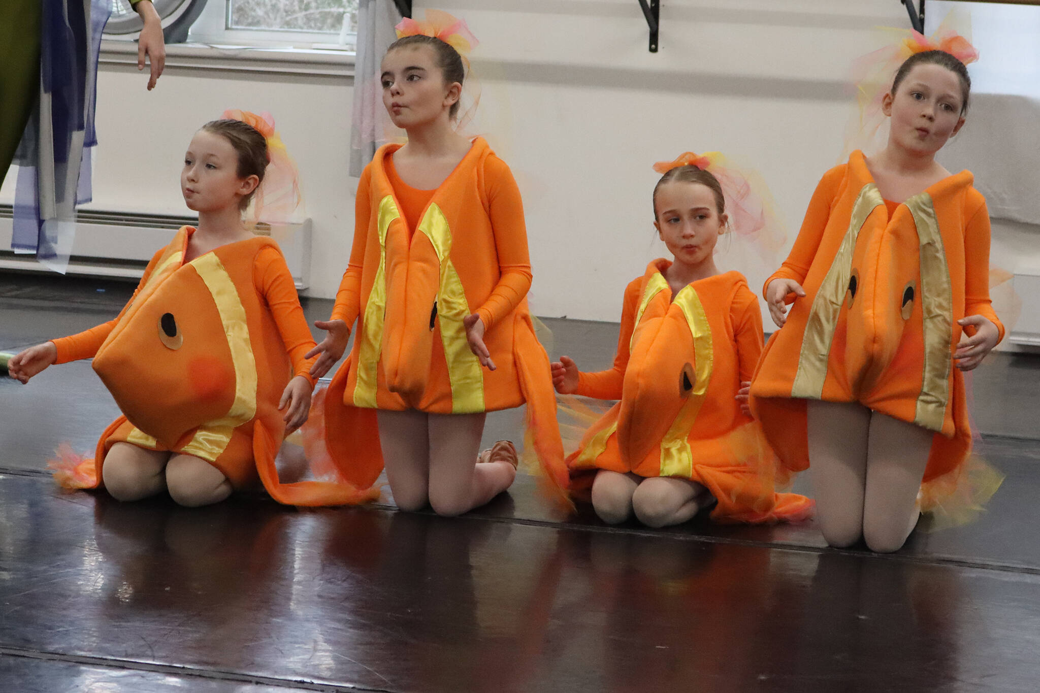 A small school of fish (left to right) Dani Hayes, Andie Reid, Scotlyn Beck and Avery McCarthy take in the action during rehearsal for “Carnival of Animals.” Juneau Dance. (Ben Hohenstatt / Juneau Empire)