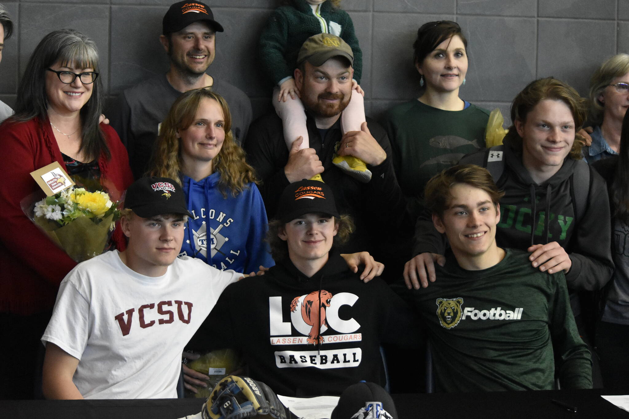 photos by Peter Segall / Juneau Empire
From left to right in front: Thunder Mountain High School students Noah Chambers, Wallace Adams and Preston Williams — who all grew up together on the same street — all signed on to play college sports at schools out of state on Wednesday.