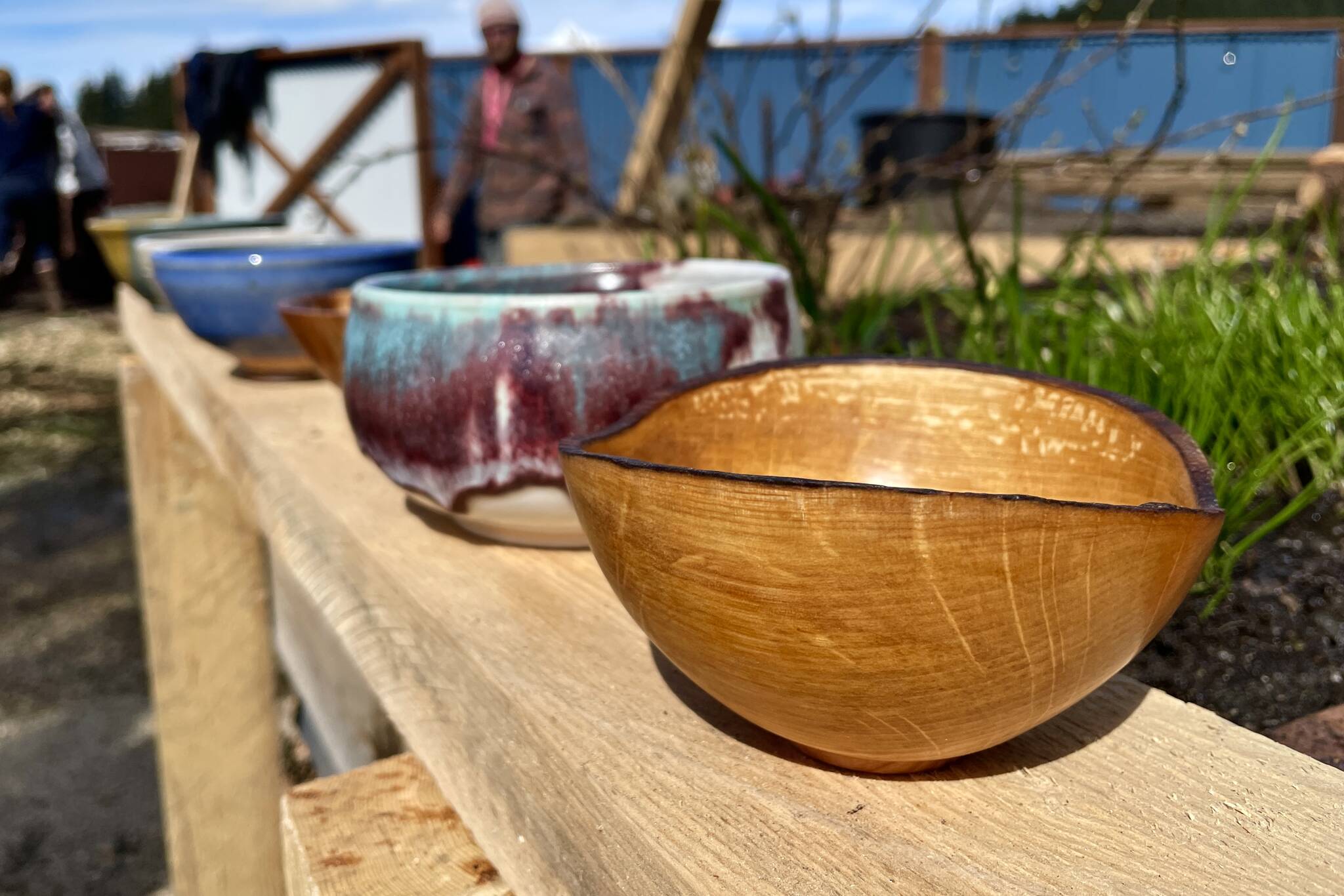 Some of the bowls available for selection by attendees of the Empty Bowls event, the Glory Hall’s annual fundraiser, sit on display at the shelter’s new garden. (Michael S. Lockett / Juneau Empire)