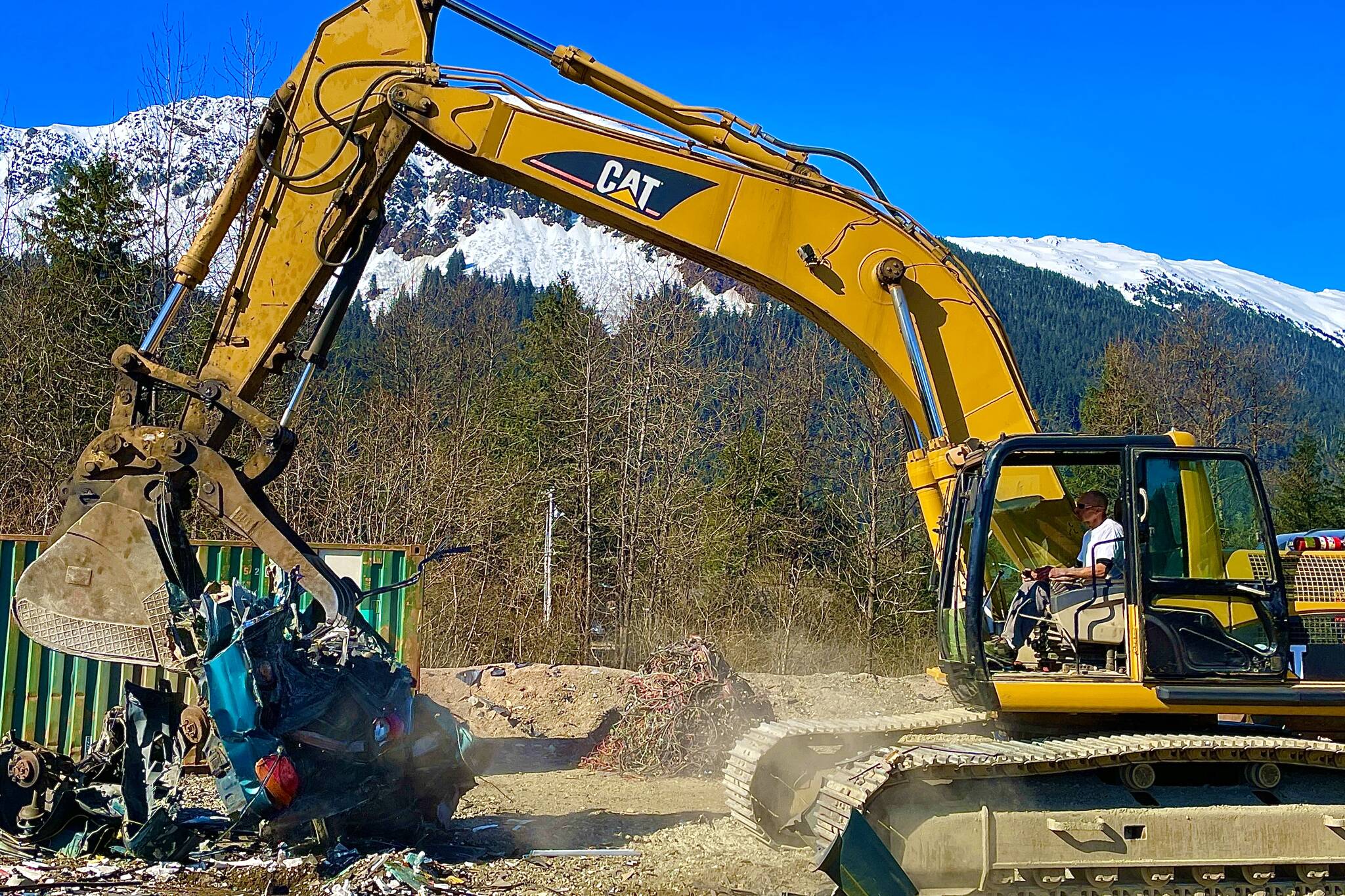 Joe Shockley prepares a car for baling at Skookum Recycling on April 19, 2022. Skookum is partnered with the City and Borough of Juneau to dispose of junk cars for free for the first 50 registrants beginning on April 22, 2022. (Michael S. Lockett / Juneau Empire)