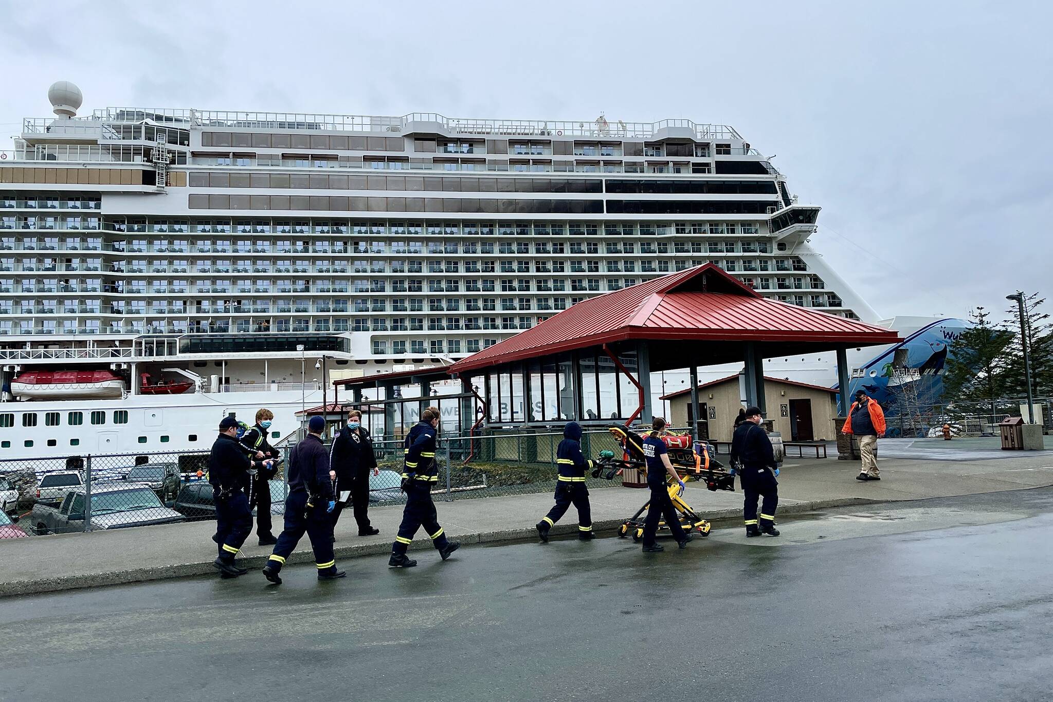 Capital City Fire/Rescue personnel go to transport a patient for medevac from the Norwegian Bliss, the first vessel of the 2022 cruise season, on April 25, 2022. (Michael S. Lockett / Juneau Empire)