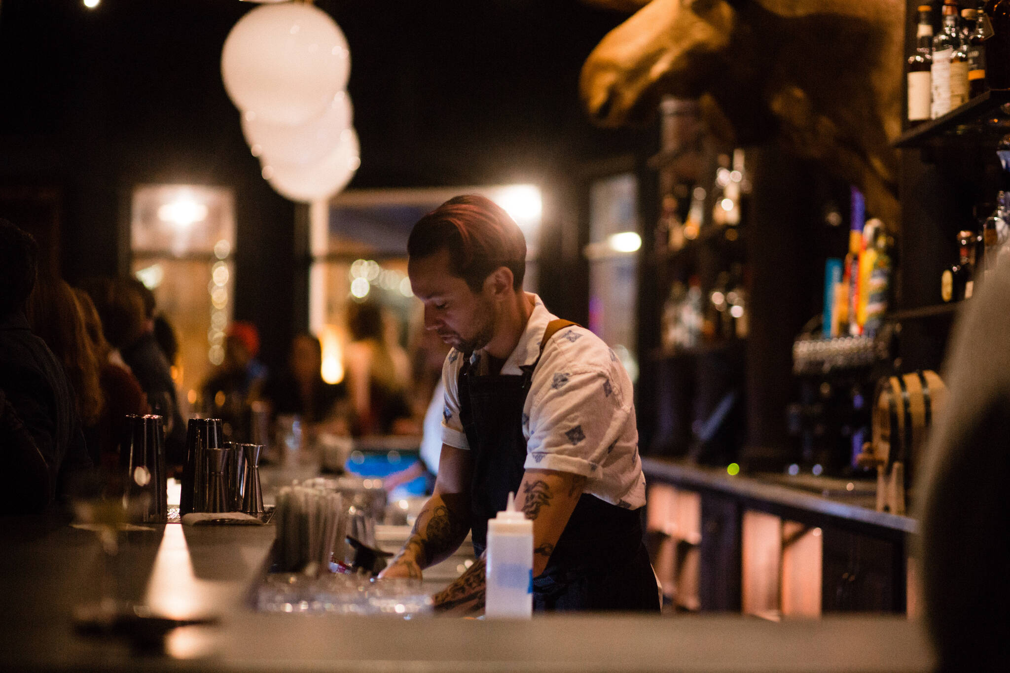 Bartender Logan Terry pours a drink during an opening event for the Crystal Saloon, a newly overhauled bar downtown. (Courtesy photo / Sydney Akagi Photography)