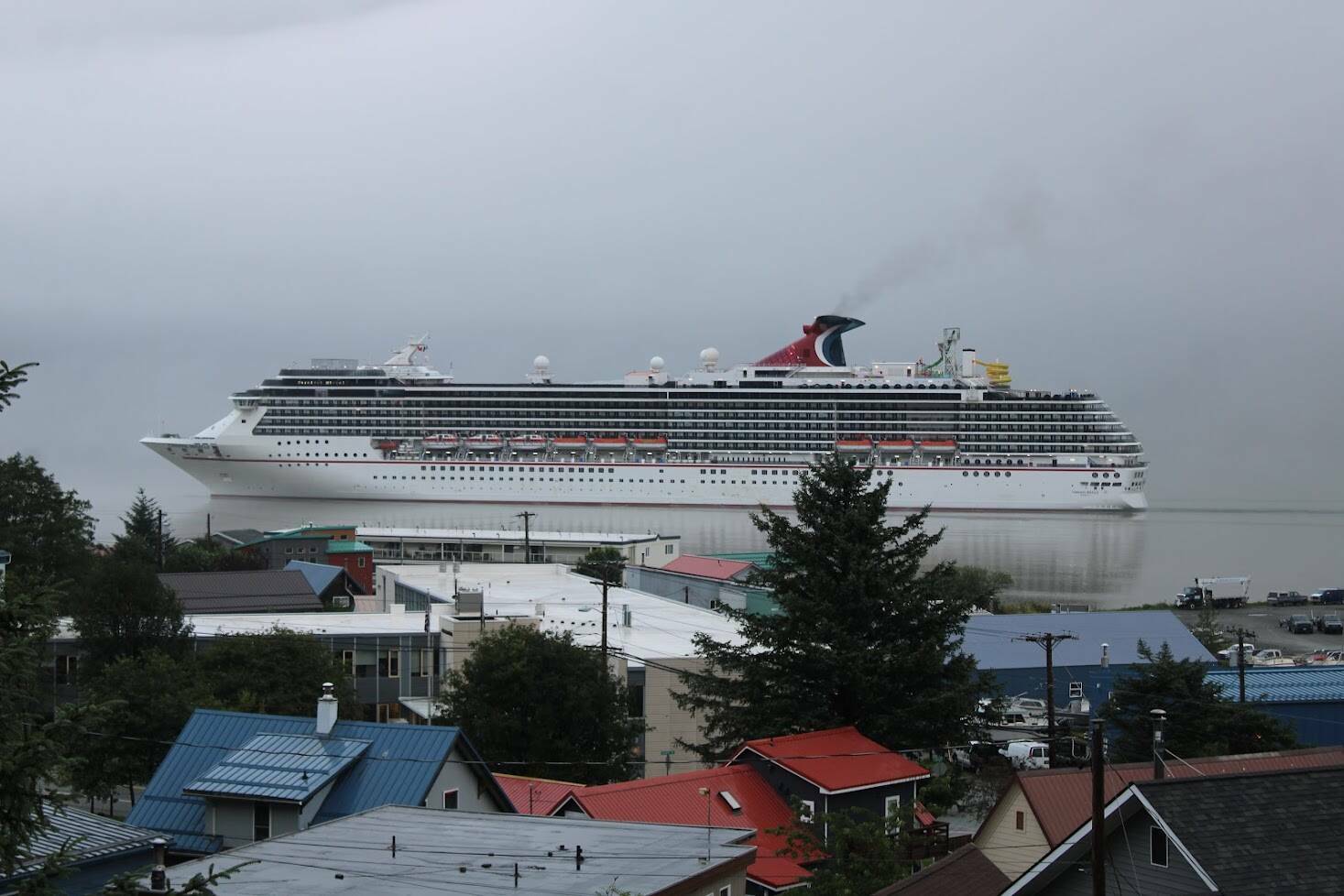 A Carnival Cruise Lines vessel similar to one due in Juneau following a COVID outbreak aboard steams past Douglas in 2021. (Dana Zigmund / Juneau Empire File)