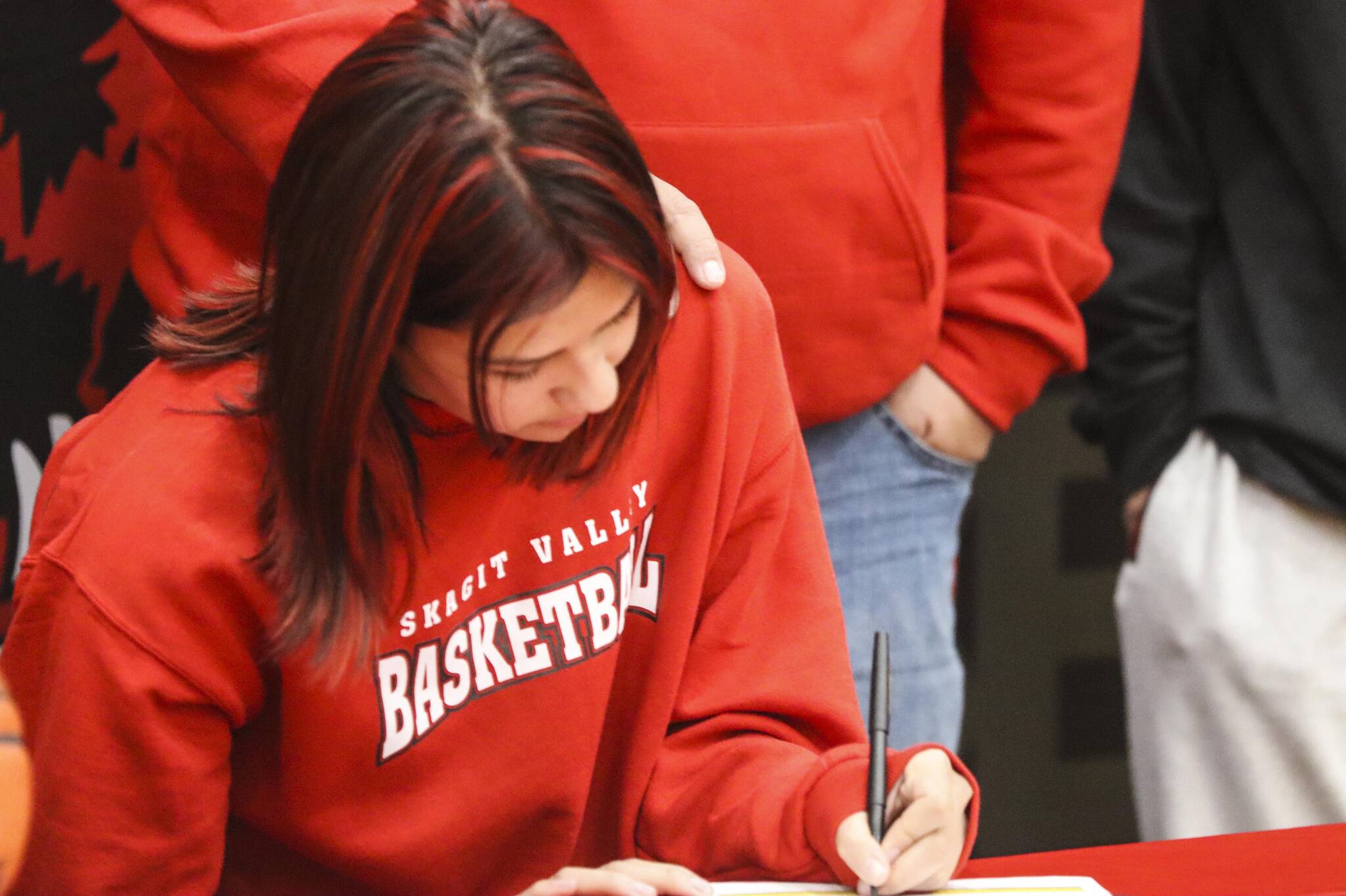 JDHS basketball player Trinity Jackson signs her letter of intent to play basketball for Skagit Valley College on May 4, 2022. (Michael S. Lockett / Juneau Empire)