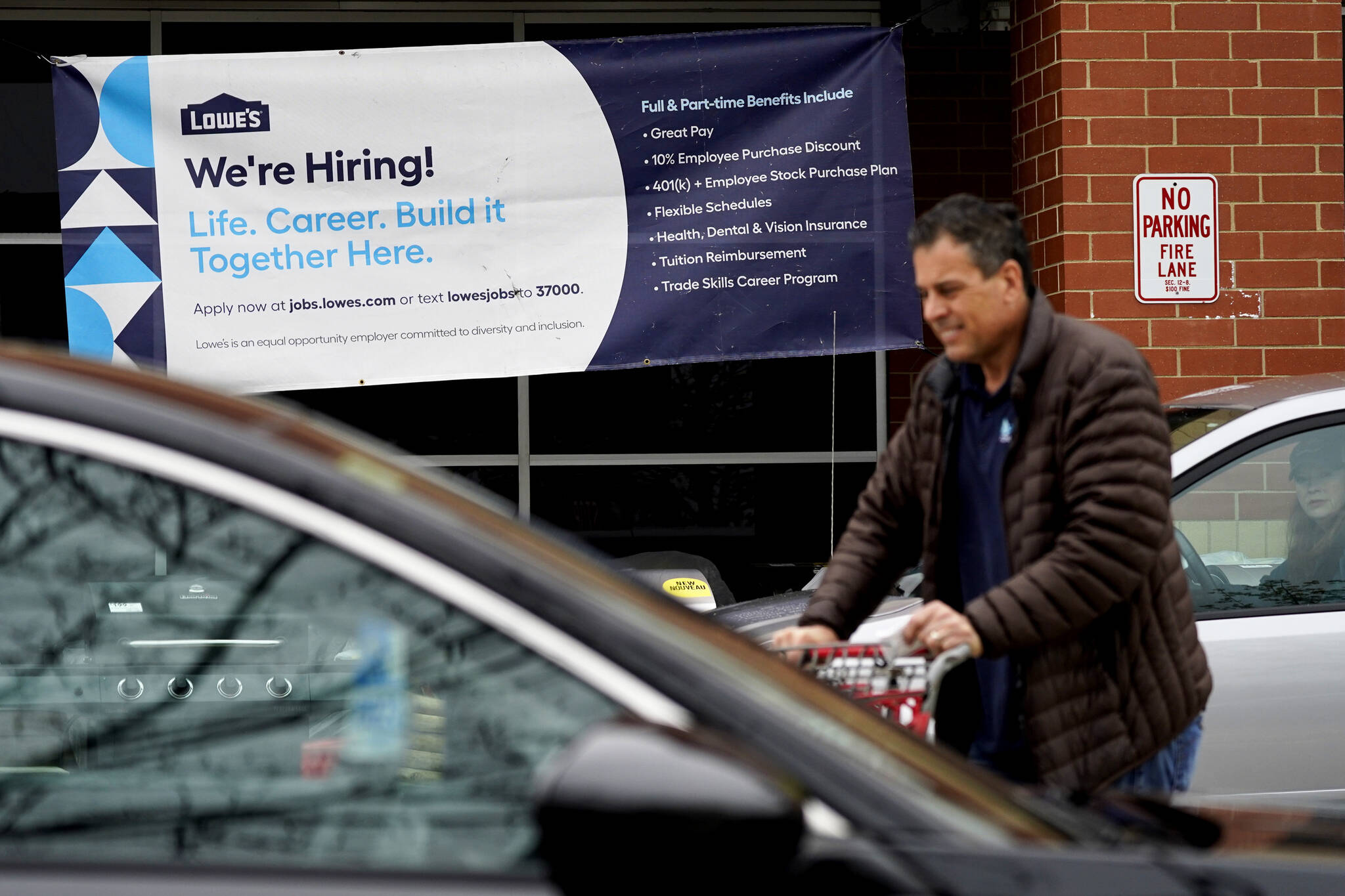 A hiring sign is displayed at a home improvement store in Northbrook, Ill., Thursday, May 5, 2022. America’s employers added 428,000 jobs in April, extending a streak of solid hiring that has defied punishing inflation, chronic supply shortages, the Russian war against Ukraine and much higher borrowing costs. (AP Photo / Nam Y. Huh)