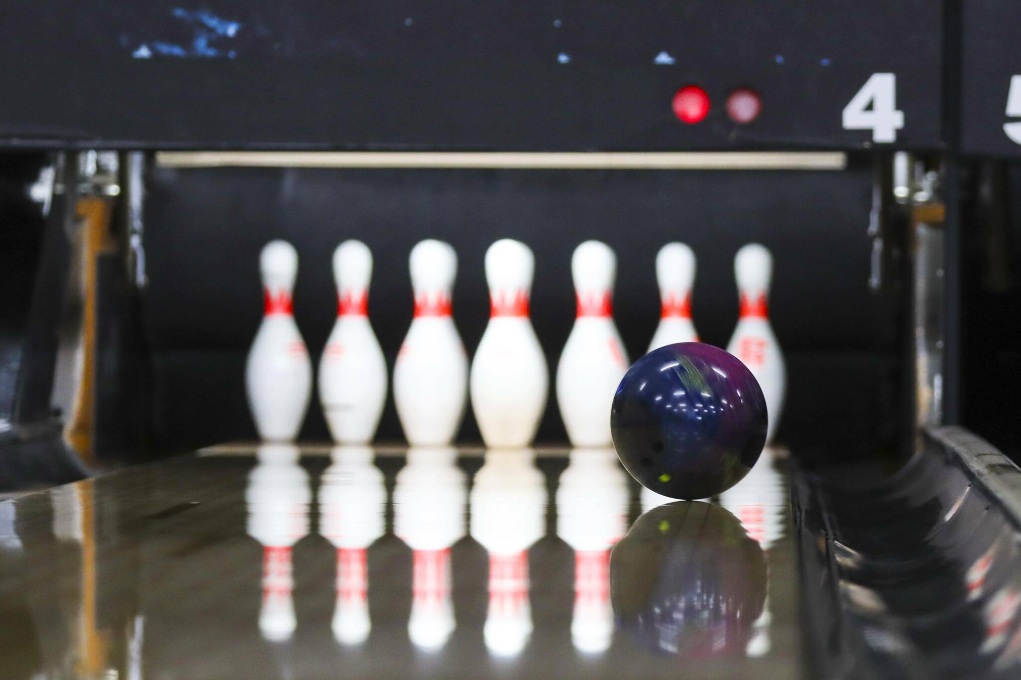 A ball streaks down the lane at an unbroken formation of pins at Pinz, Juneau’s bowling alley, on May 5, 2022. (Michael S. Lockett / Juneau Empire)