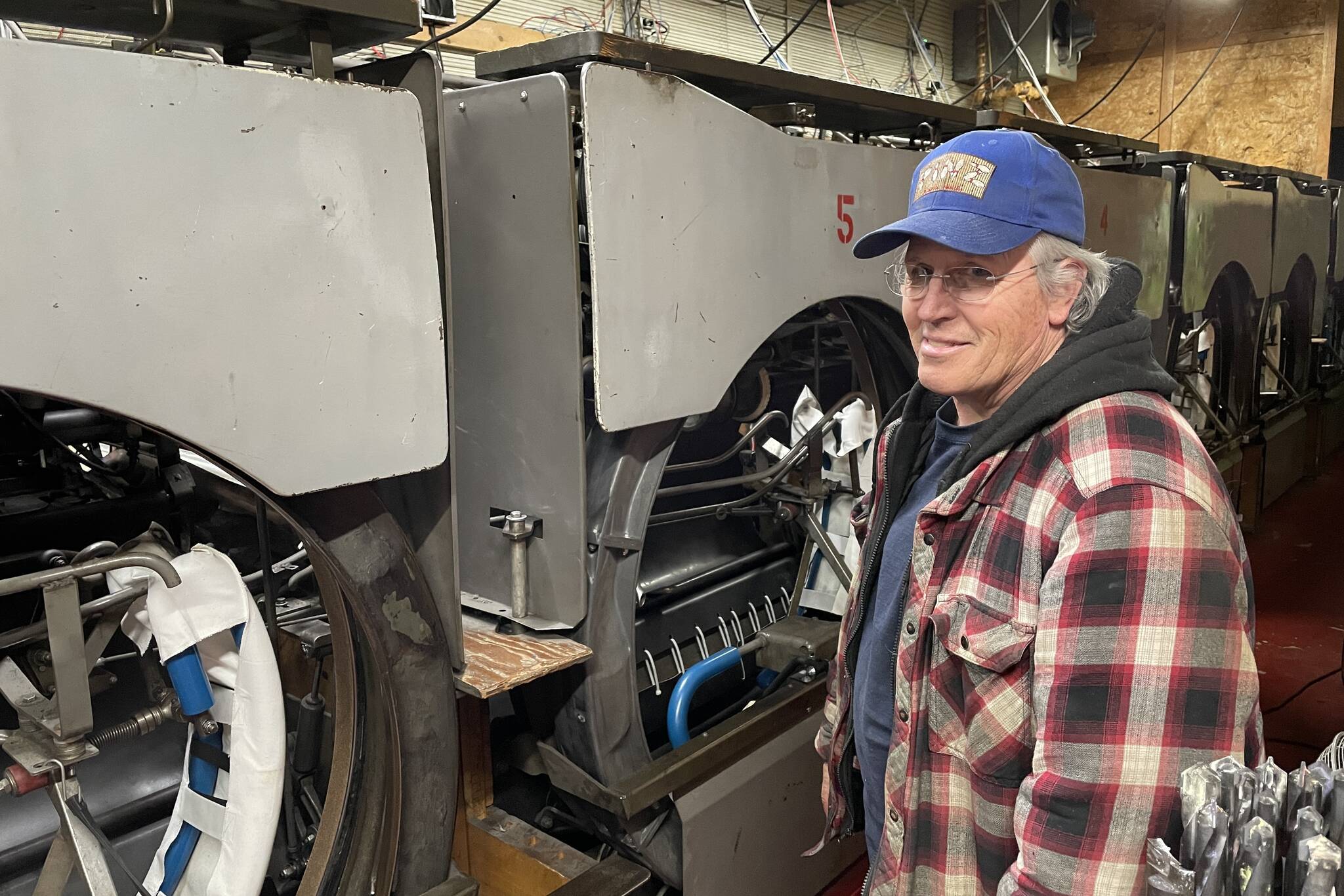 Bob Petersen, who took over Pinz several years ago, gestures at the machinery behind on the lanes on May 5, 2022. (Michael S. Lockett / Juneau Empire)