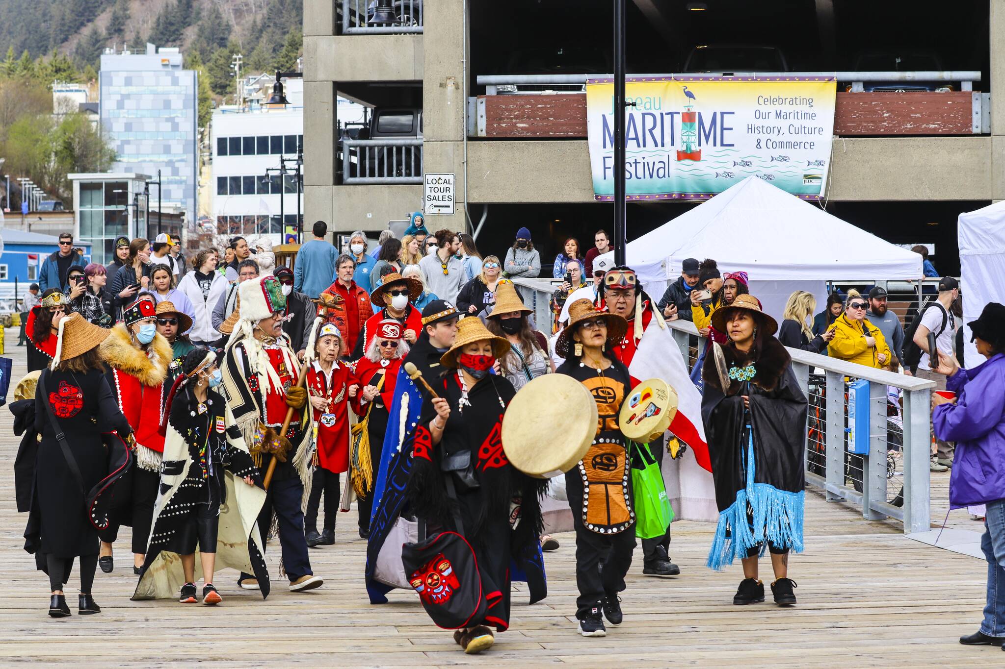 Members of the Yées Ḵu.oo multicultural dance group advance up the pier during the 12th Annual Maritime Festival on May 7, 2022. (Michael S. Lockett / Juneau Empire)