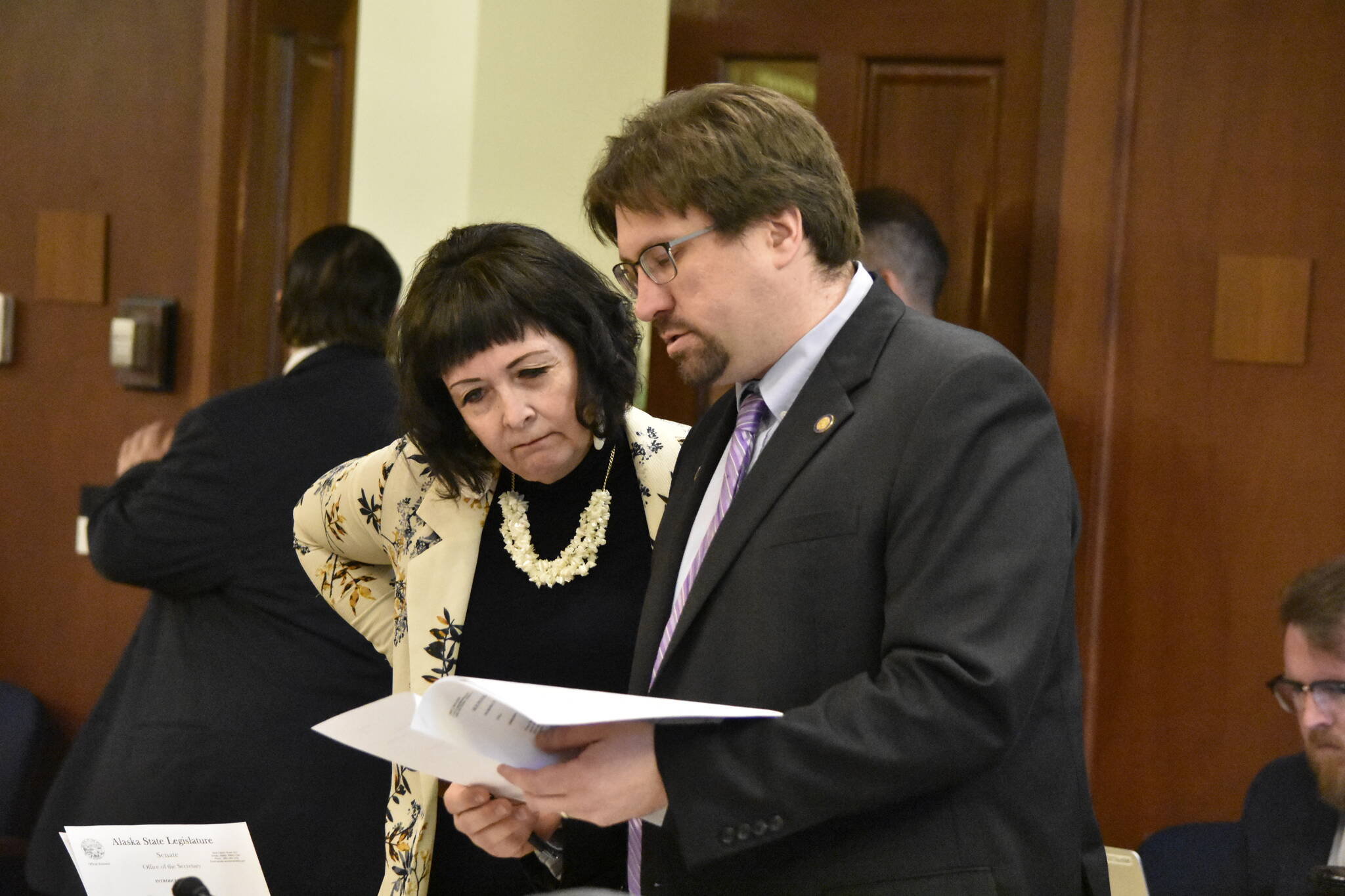 Sens. Shelley Hughes, R-Palmer, left, and Robert Myers, R-North Pole, read through one of 41 amendments submitted to the state’s omnibus budget bill being debate on the floor of the Alaska State Senate on Monday, May 9, 2022. (Peter Segall / Juneau Empire)