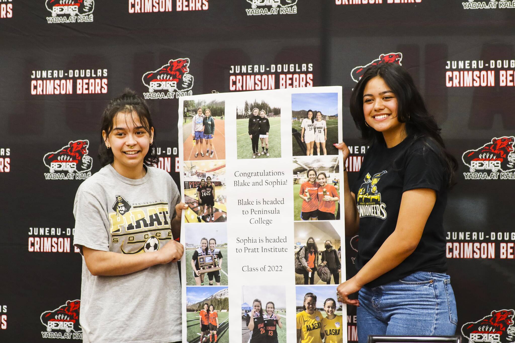 JDHS girls soccer players Blake Plummer, left, and Sophia Pugh who just signed their letters of intent to play college soccer at separate schools, pose with a tribute to their long time playing together on May 9, 2022. (Michael S. Lockett / Juneau Empire)