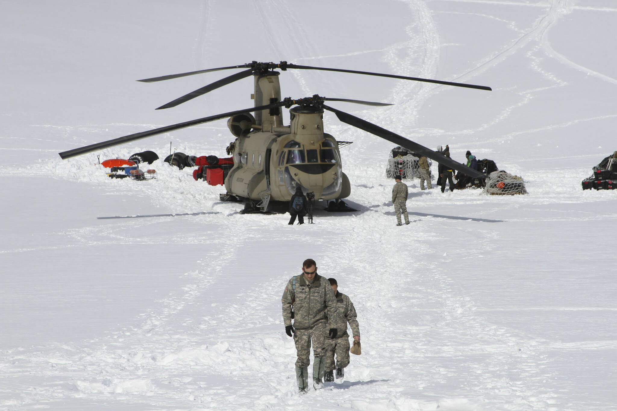 Capt. Corey Wheeler, front, commander of B Company, 1st Battalion, 52nd Aviation Regiment at Fort Wainwright, Alaska, walks away from a Chinook helicopter that landed on the glacier near Denali, April 24, 2016, on the Kahiltna Glacier in Alaska. The U.S. Army helped set up base camp on North America’s tallest mountain. The U.S. Army is poised to revamp its forces in Alaska to better prepare for future cold-weather conflicts, and it is expected to replace the larger, heavily equipped Stryker Brigade there with a more mobile, infantry unit better suited for the frigid fight, according to Army leaders. (AP Photo/Mark Thiessen, File)
