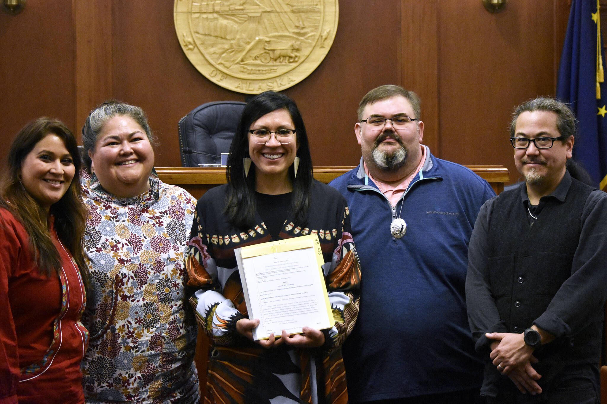 From left to right, ‘Wáahlaal Gidáak Barbara Blake, La quen náay Liz Medicine Crow, Rep. Tiffany Zulkowsky, D-Bethel; Richard Chalyee Éesh Peterson and Joe Nelson on Friday, May 13, 2022, pose with the text of House Bill 123, a bill sponsored by Zulkosky to have the state formally recognize Alaska’s 229 federally-recognized tribes. (Peter Segall / Juneau Empire)