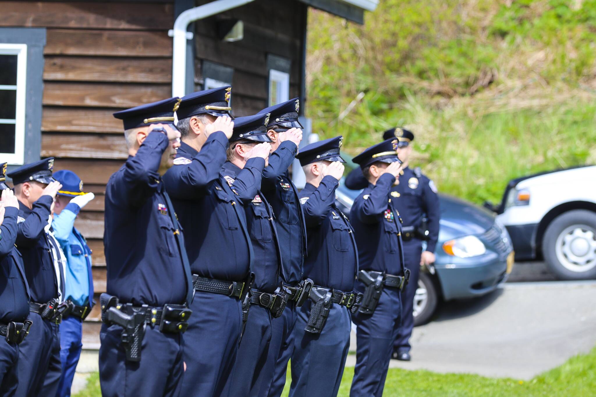 Michael S. Lockett / Juneau Empire
Law enforcement personnel salute as officer lay a ceremonial wreath on the grave of a dead officer at Evergreen Cemetery for Peace Officers Memorial Day on May 13, 2022.